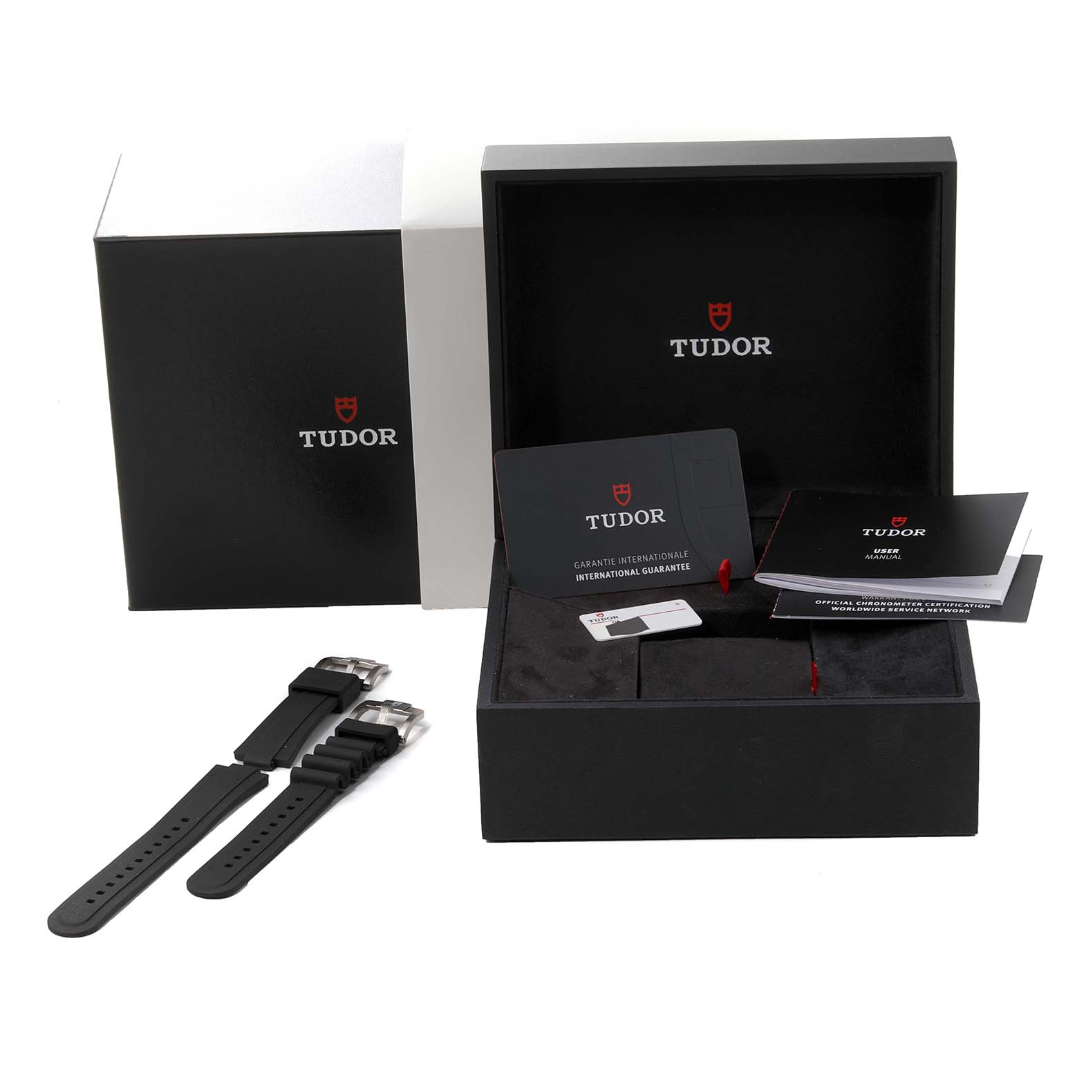 The image shows a Tudor Pelagos 25407N Men
s Titanium Black Dial 25407N Men
s Titanium Black Dial watch box, warranty cards, manuals, and two black rubber straps.