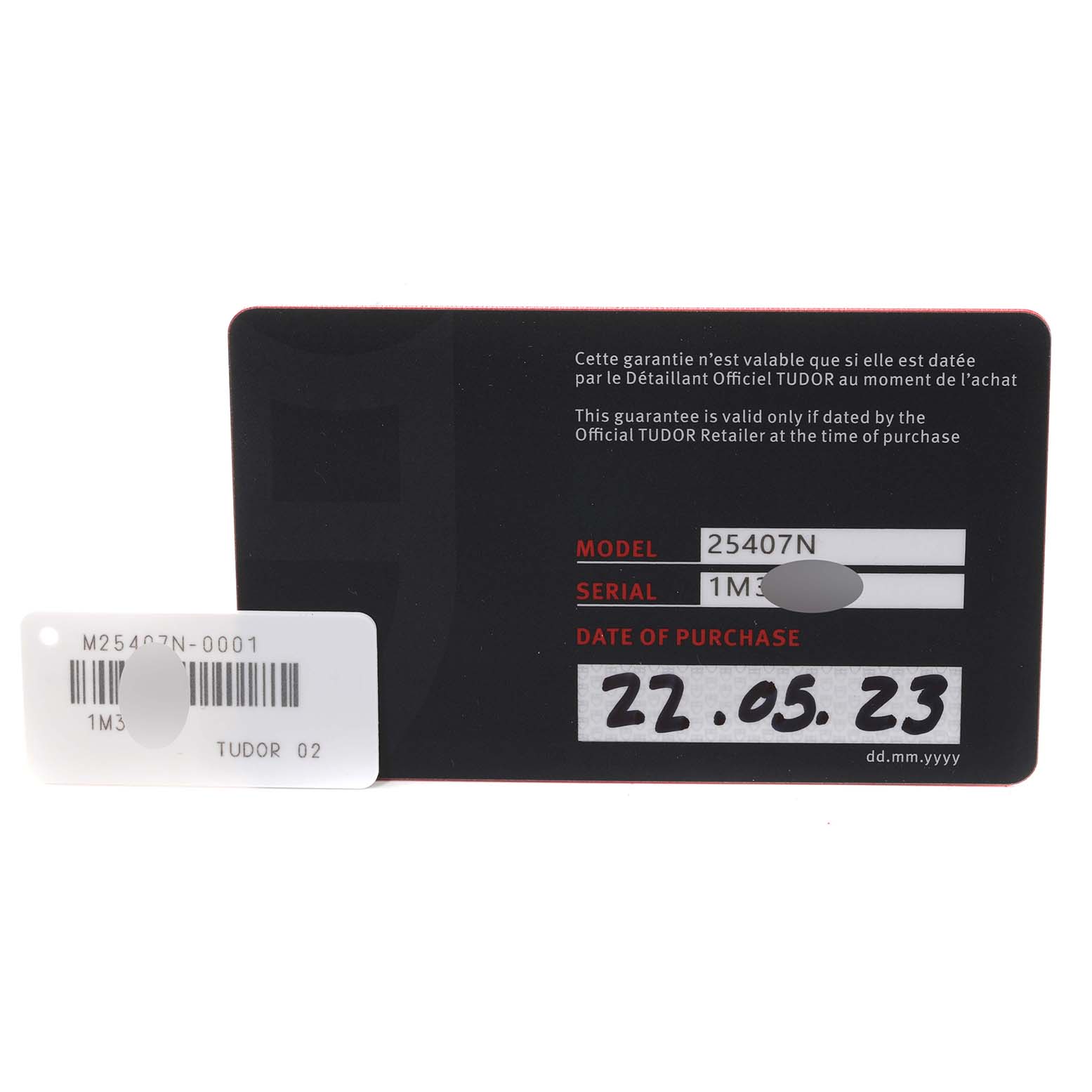 The image shows the warranty card for a Tudor Pelagos 25407N Men
s Titanium Black Dial 25407N Men
s Titanium Black Dial watch model and a serial number tag.