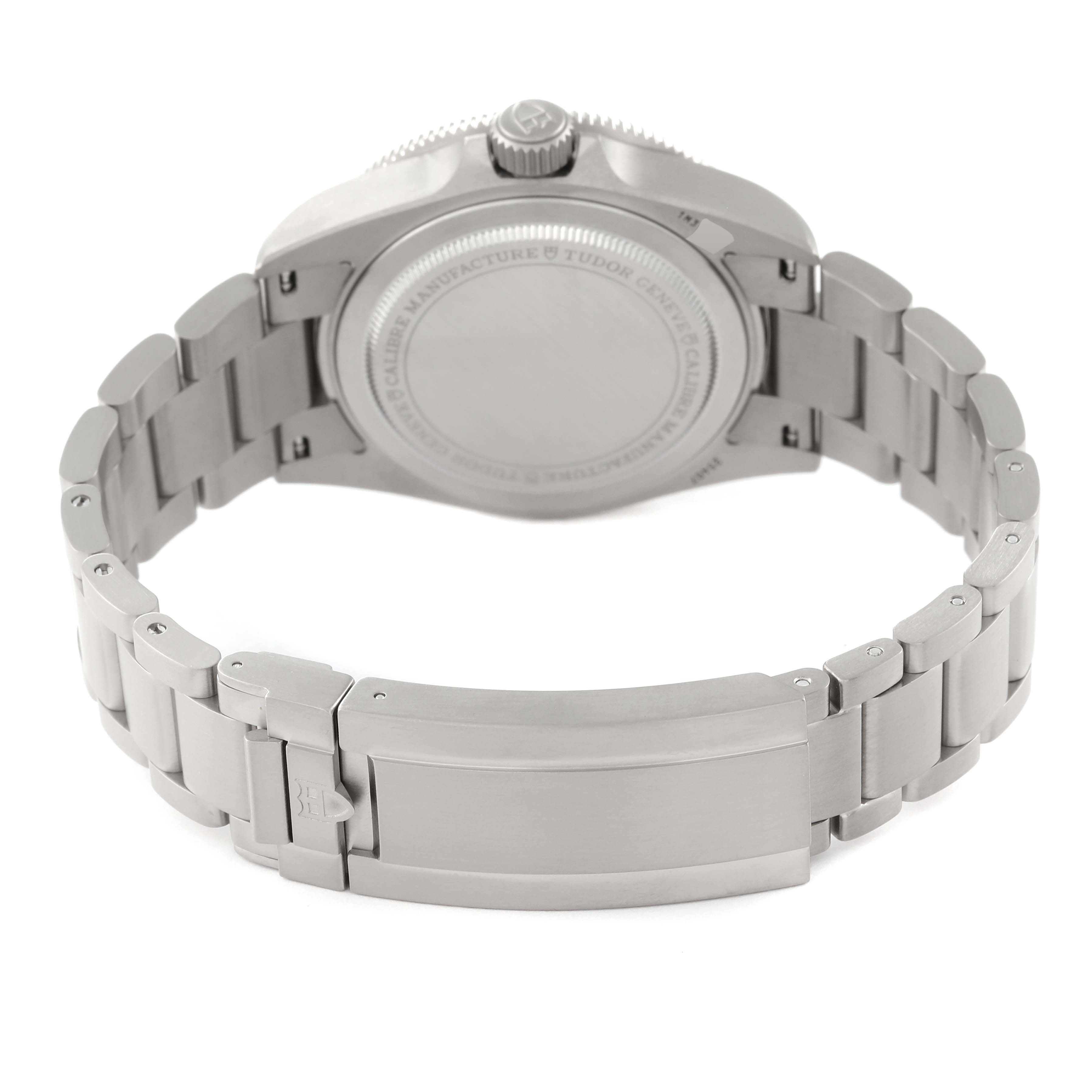 The image shows the backside and clasp of a Tudor Pelagos 25407N Men
s Titanium Black Dial 25407N Men
s Titanium Black Dial watch, including the case back and part of the metal bracelet.