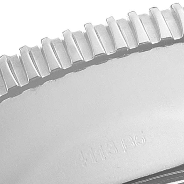 The image shows a macro shot of the bezel teeth of the Superocean watch by Breitling.