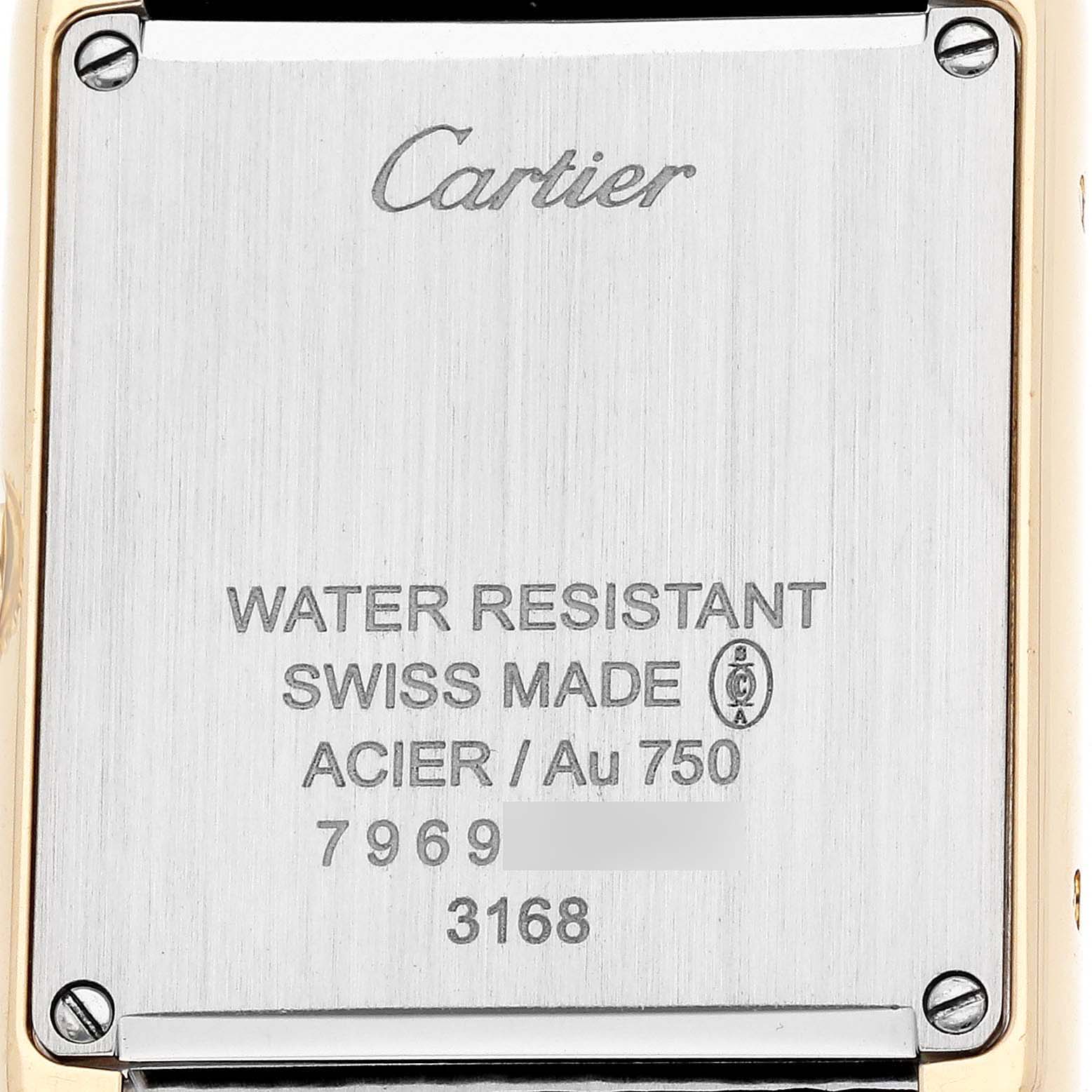 The image shows the back of a Cartier Tank Solo W5200002 Women's Yellow Gold Silver Dial watch, displaying engravings and screws.