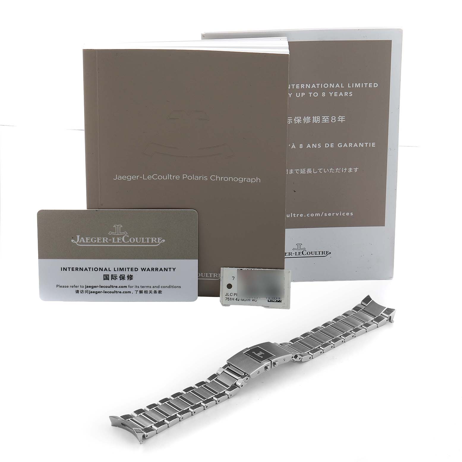 The image shows a Jaeger LeCoultre Polaris Q9028480 Men's Stainless Steel Black Dial watch bracelet, warranty card, and manuals from a top-down angle.