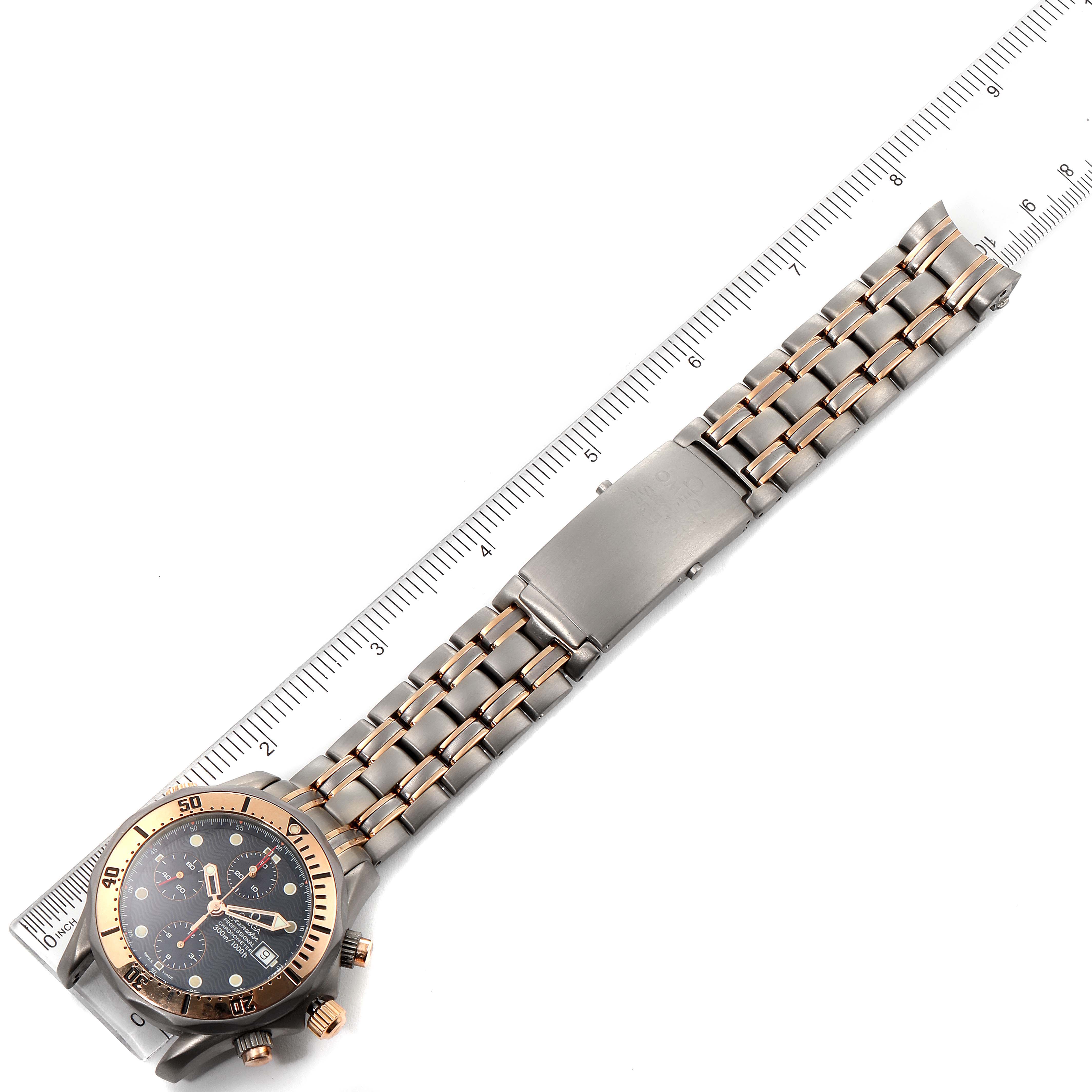 The Omega Seamaster 2296.80.00 Men's Titanium Blue Dial 2296.80.00 Men's Titanium Blue Dial watch is shown from a top-down angle, displaying the face, bezel, and full metal bracelet with a measuring ruler beside it.