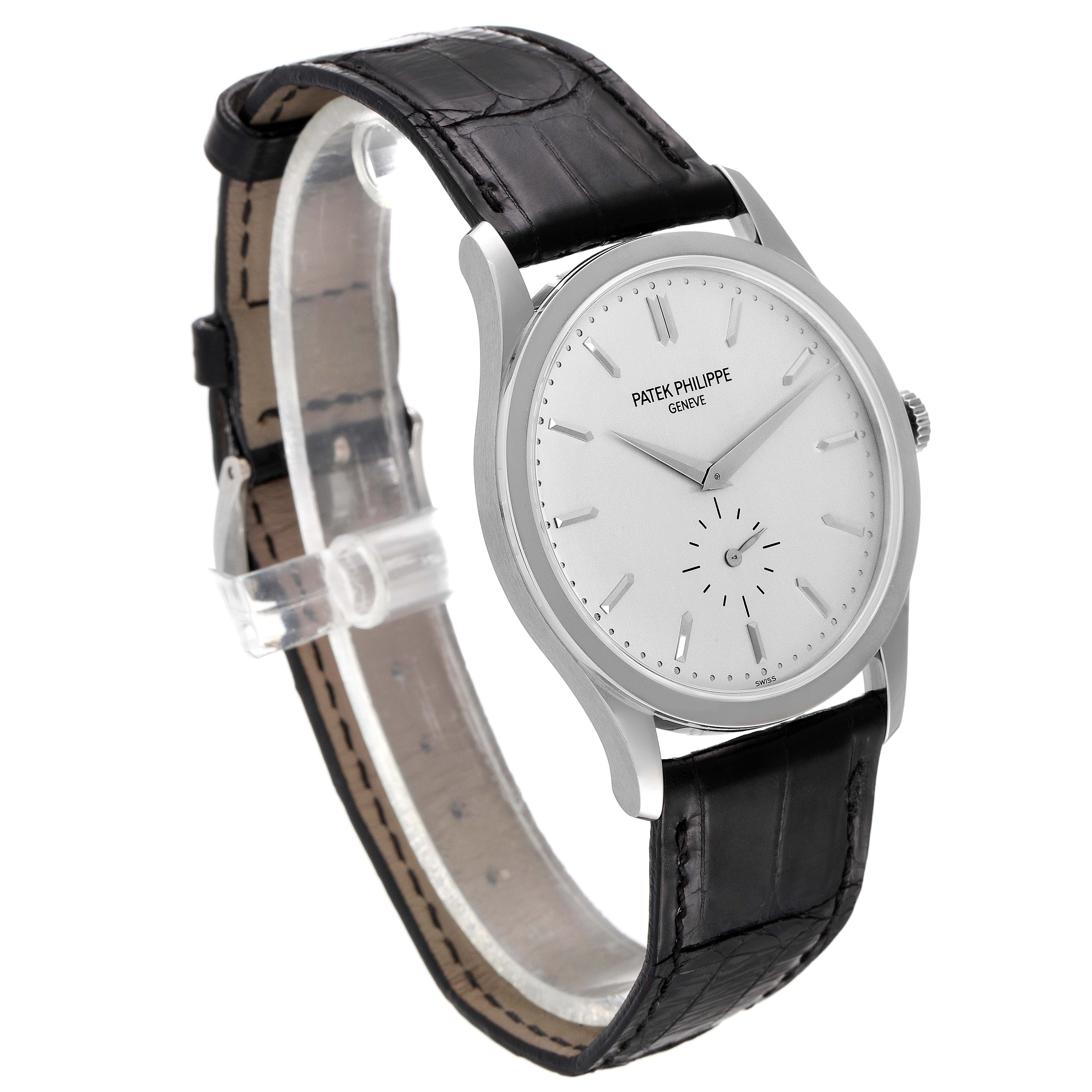 The image shows a Patek Philippe Calatrava 5196G Men's White Gold Silver Dial 5196G Men's White Gold Silver Dial watch at a slight angled view, highlighting its white dial, black leather strap, and silver case.