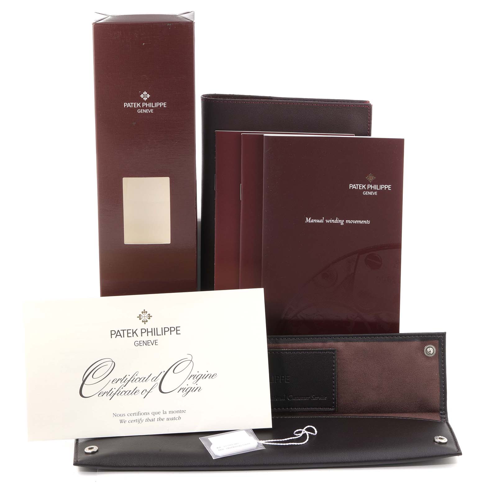 The image shows the box, manuals, certificate of origin, and a leather pouch for the Patek Philippe Calatrava 5115G Men's White Gold White Dial 5115G Men's White Gold White Dial model.