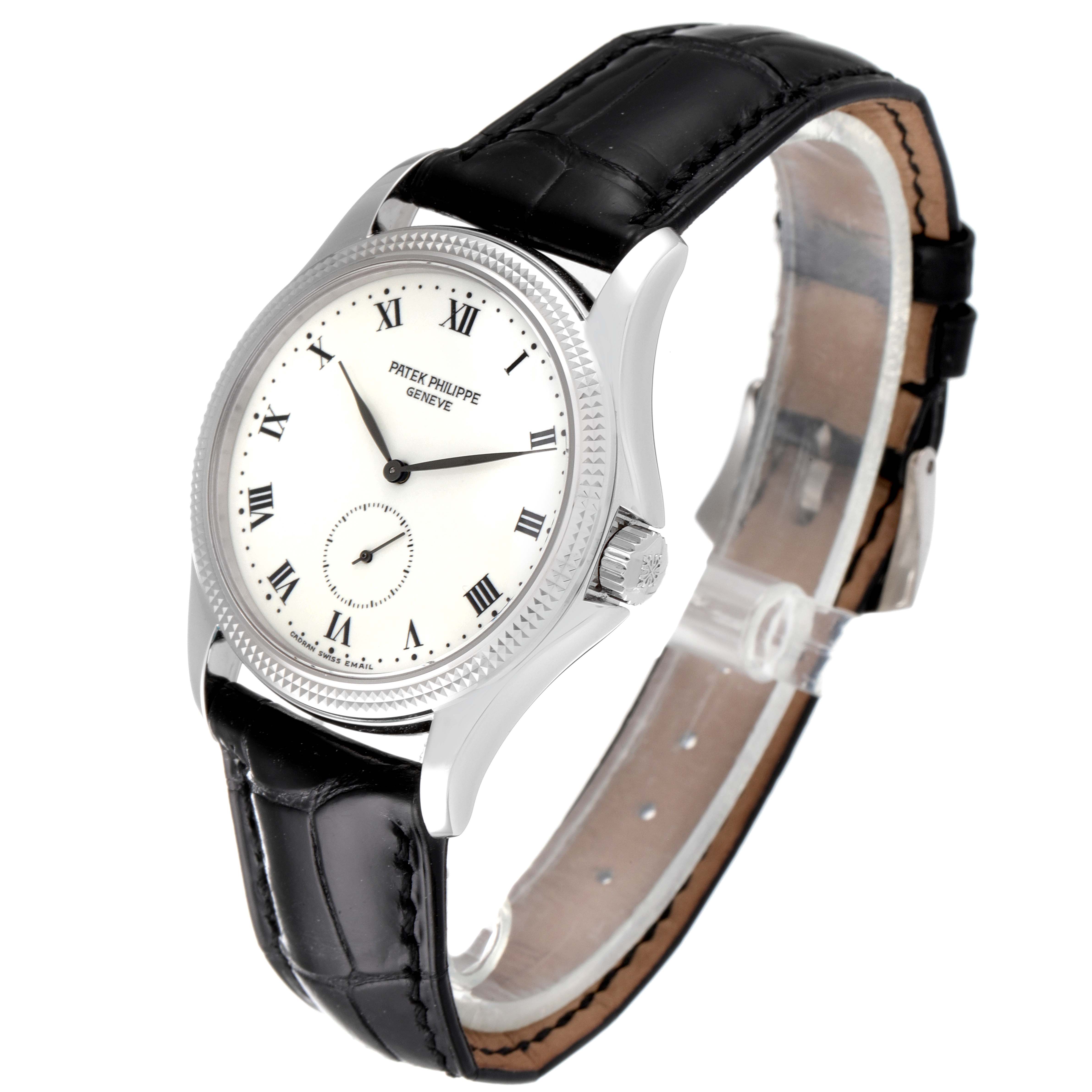 The image shows a Patek Philippe Calatrava 5115G Men's White Gold White Dial 5115G Men's White Gold White Dial watch at a slightly tilted angle, highlighting the dial, crown, case, and black leather strap.