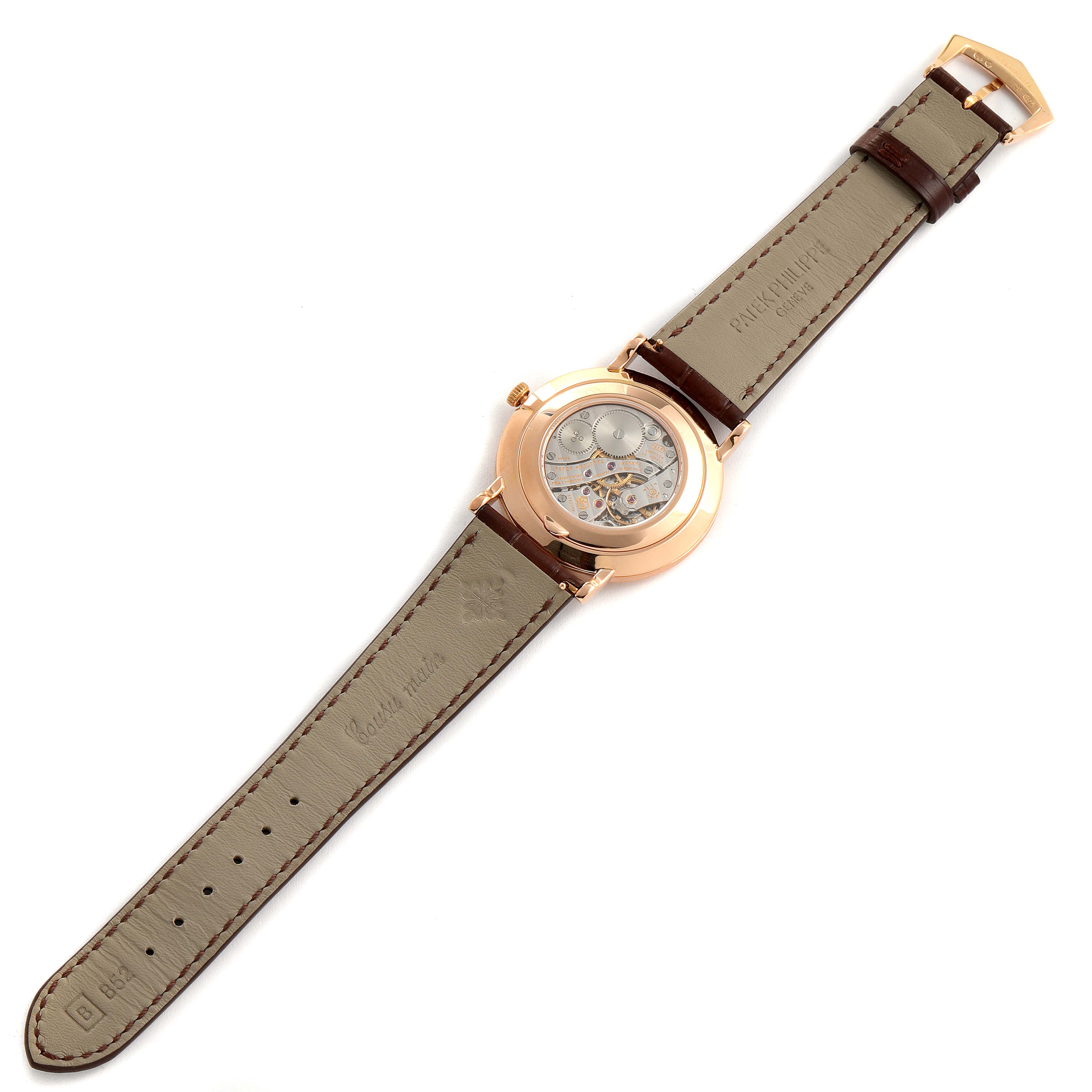 The image shows the back view of a Patek Philippe Calatrava 5119R-001 Men's Rose Gold White Dial 5119R-001 Men's Rose Gold White Dial watch, displaying the movement and the leather strap.