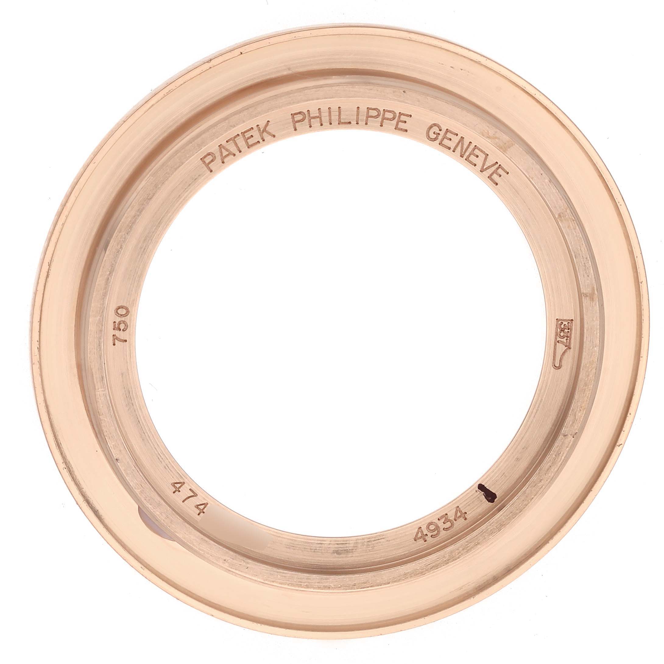 The image shows the rose gold bezel of a Patek Philippe Calatrava 4934R-001 Women's Rose Gold Brown Dial watch from a top-down angle with engraved details.
