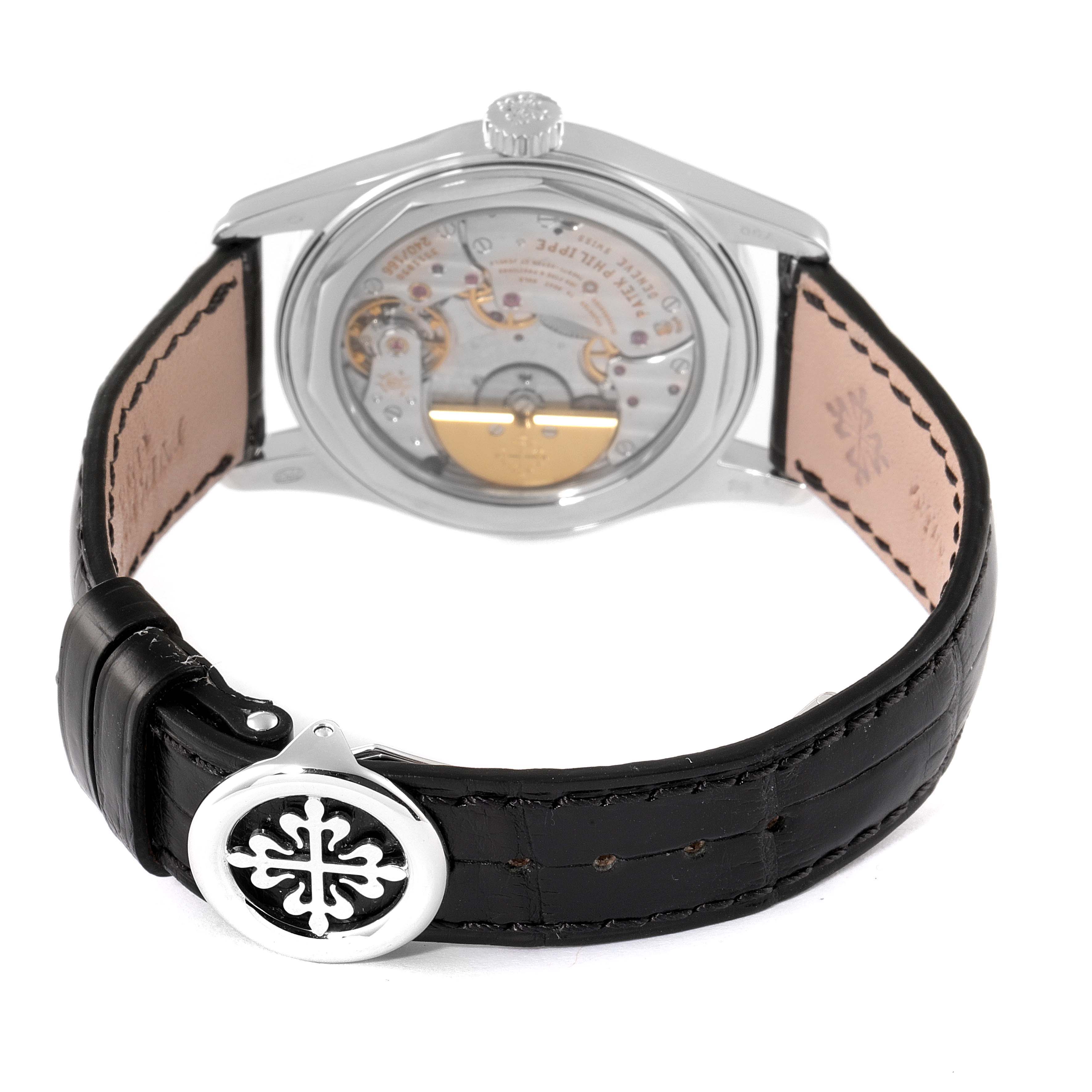 The image shows the back view of a Patek Philippe Calatrava 6000G Men's White Gold Grey Dial 6000G Men's White Gold Grey Dial model watch, highlighting its movement and leather strap with the clasp.