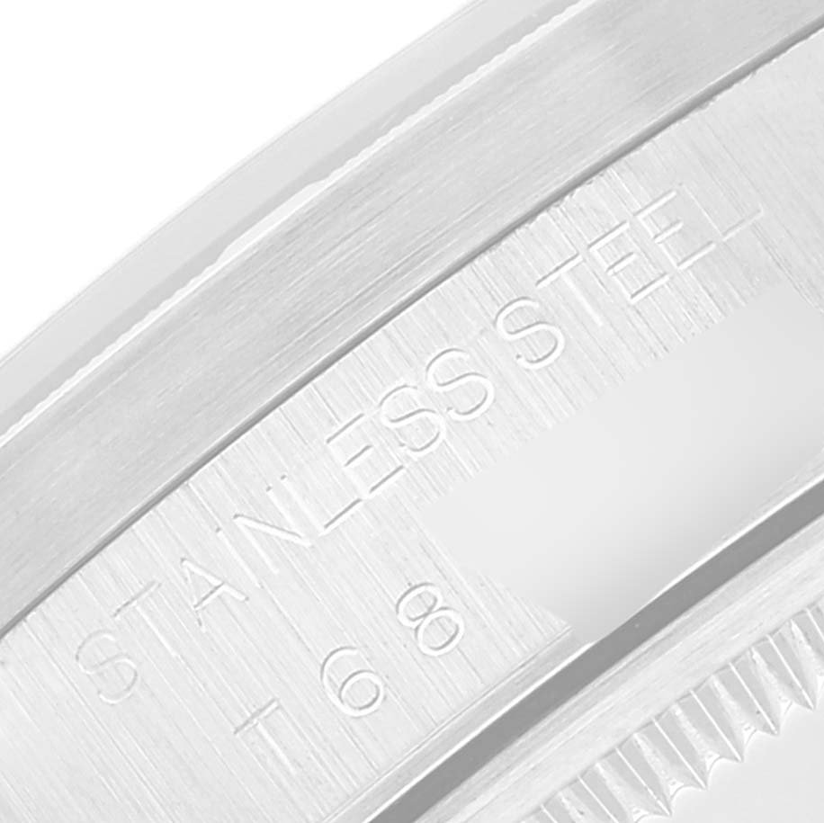 This close-up image of a Rolex Air-King 14010 Men's Stainless Steel Black Dial 14010 Men's Stainless Steel Black Dial watch shows the edge of the bezel and the engraved "STAINLESS STEEL" marking.