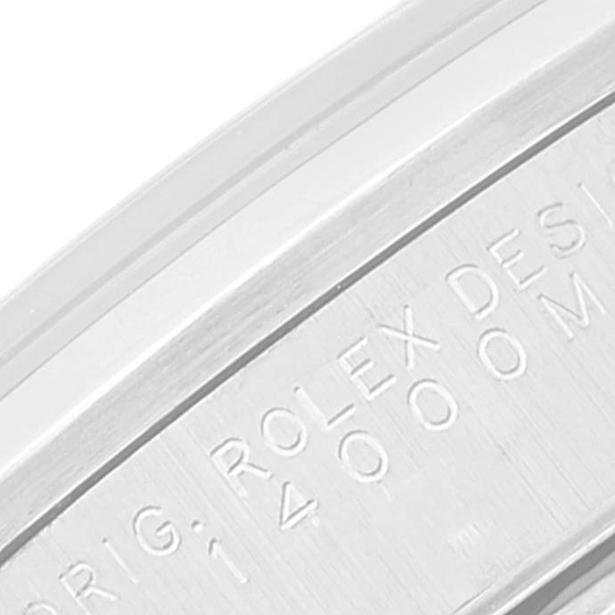 This close-up image shows part of the engraving on the case of a Rolex Air-King 14000 Men's Stainless Steel Silver Dial 14000 Men's Stainless Steel Silver Dial watch.