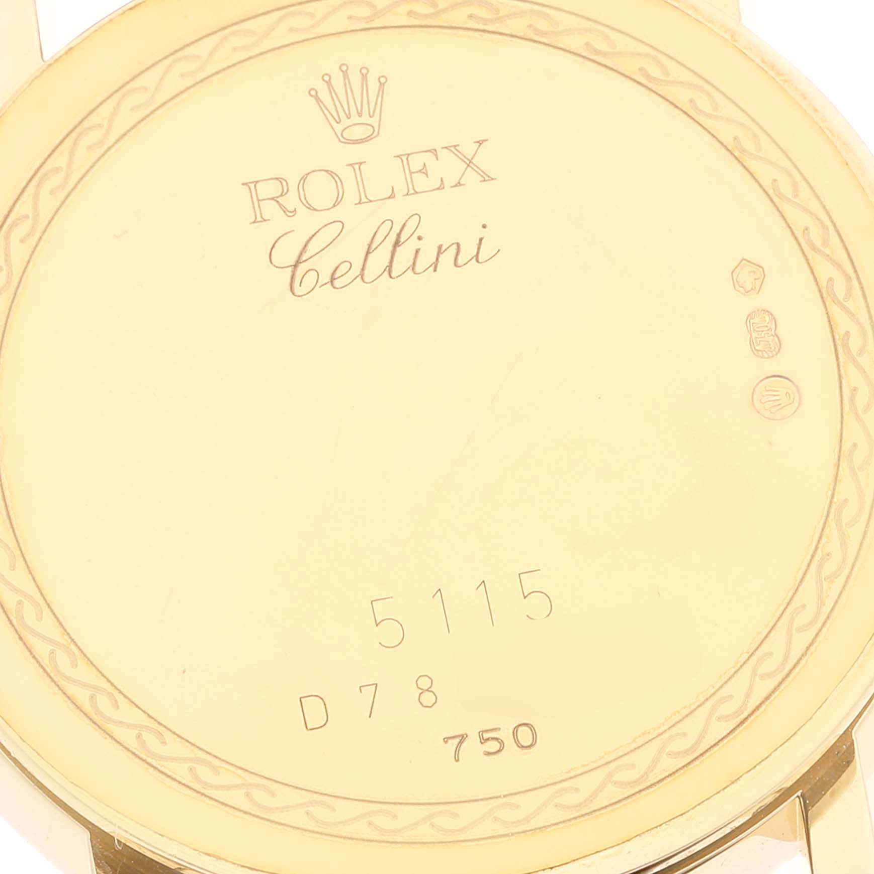 This image shows the back case of a Rolex Cellini 5115 Men
s Yellow Gold Silver Dial 5115 Men
s Yellow Gold Silver Dial watch, displaying its engravings and serial numbers.