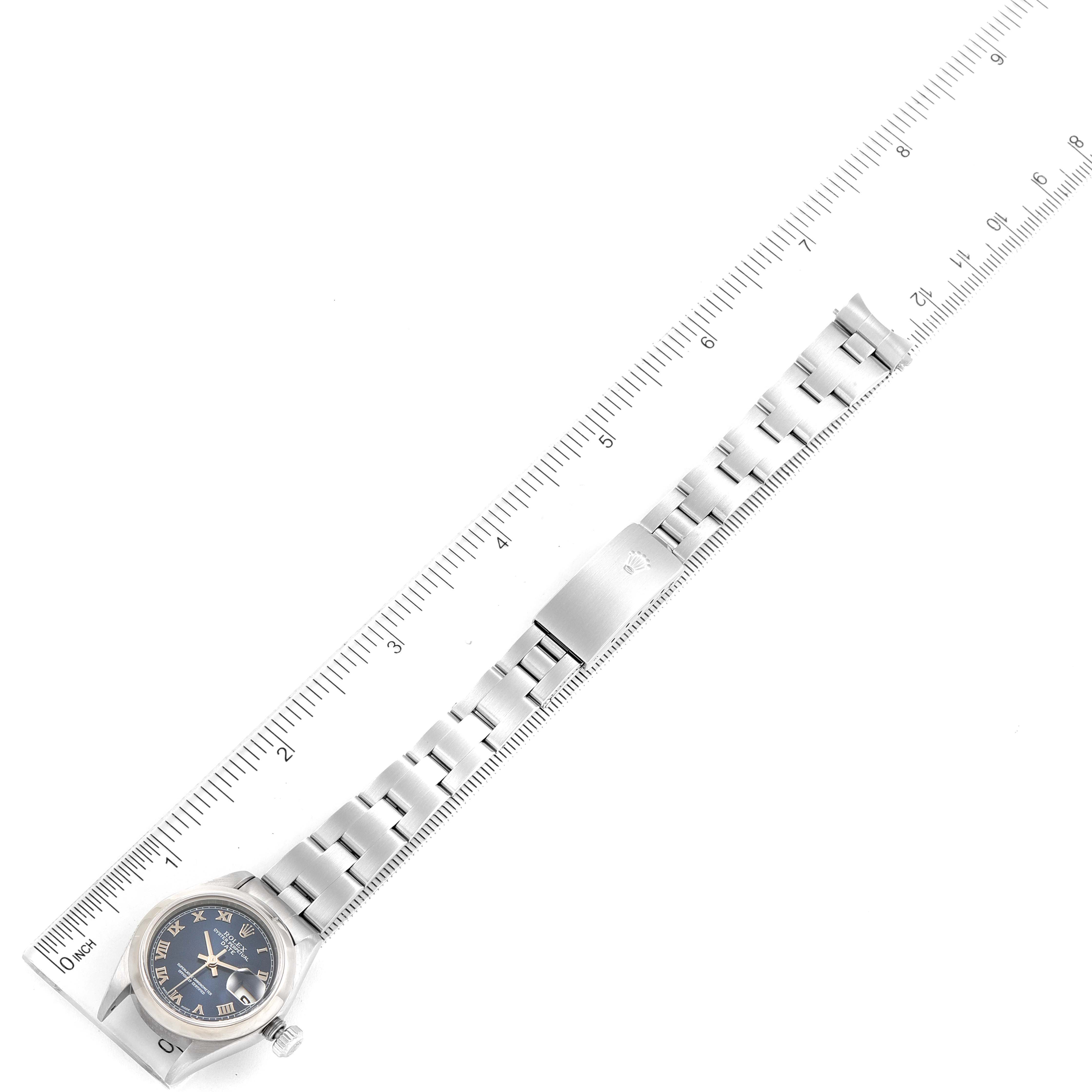 The image shows the entire Rolex Date 79160 Women
s Stainless Steel Blue Dial 79160 Women
s Stainless Steel Blue Dial model watch and band, placed next to a ruler for size reference.