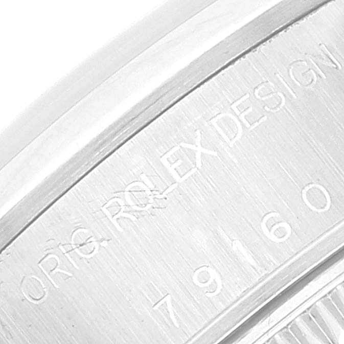 This close-up image shows part of the case back of a Rolex Date 79160 Women's Stainless Steel White Dial 79160 Women's Stainless Steel White Dial model, with the engraving "ORIG ROLEX DESIGN 79160."