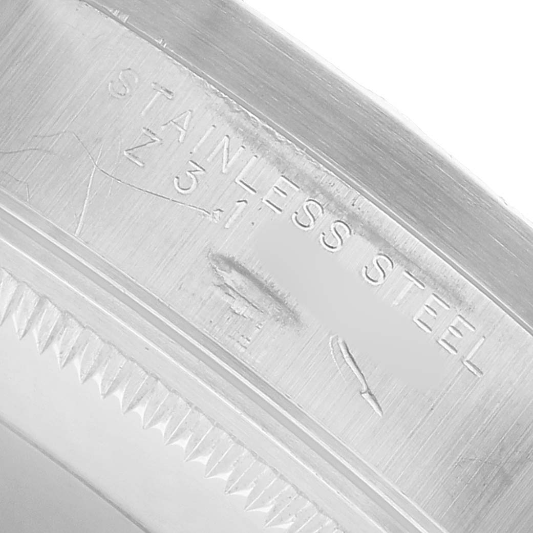 The image shows a close-up of the inner bezel markings on a Rolex Date 15210 Men's Stainless Steel Silver Dial, highlighting "Stainless Steel" details.
