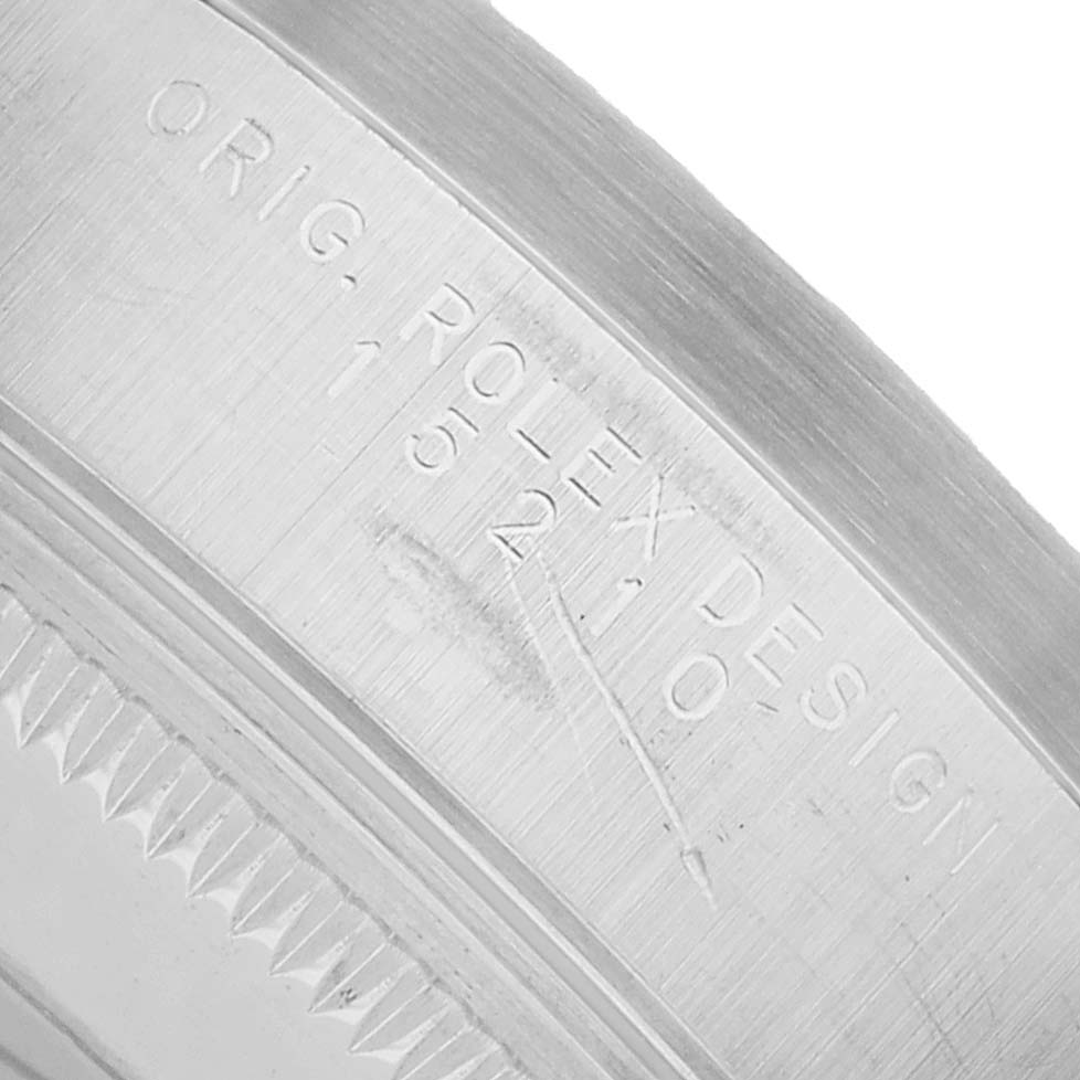 The image shows the inner bezel engraving of a Rolex Date 15210 Men's Stainless Steel Silver Dial model, focusing on the serial and model numbers.