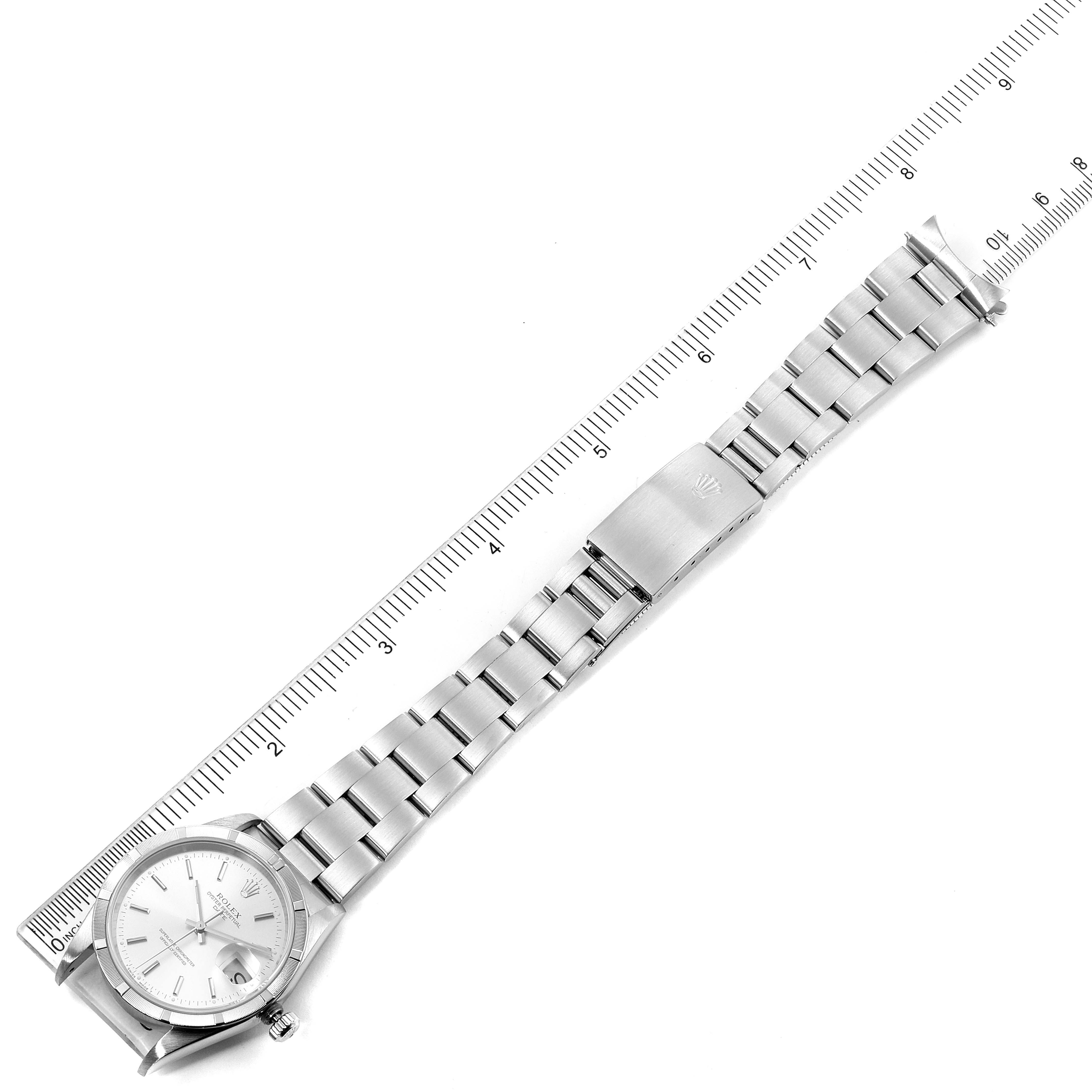 This image shows the Rolex Date 15210 Men's Stainless Steel Silver Dial 15210 Men's Stainless Steel Silver Dial model watch, including its face and the full bracelet laid out flat next to a ruler.