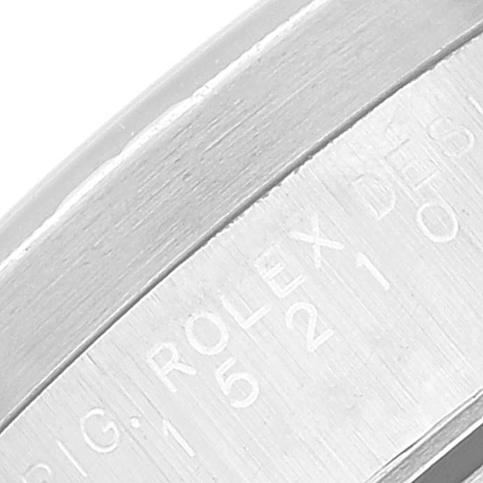 This close-up shows the engraved side of the bezel or case of a Rolex Date 15210 Men's Stainless Steel White Dial 15210 Men's Stainless Steel White Dial model watch.