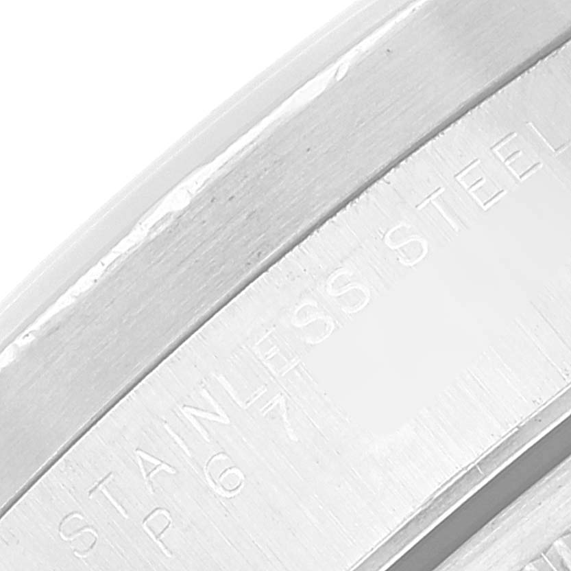 This is a close-up image of the inner watch case of a Rolex Date 15210 Men's Stainless Steel White Dial 15210 Men's Stainless Steel White Dial model, showing part of the stainless steel inscription.