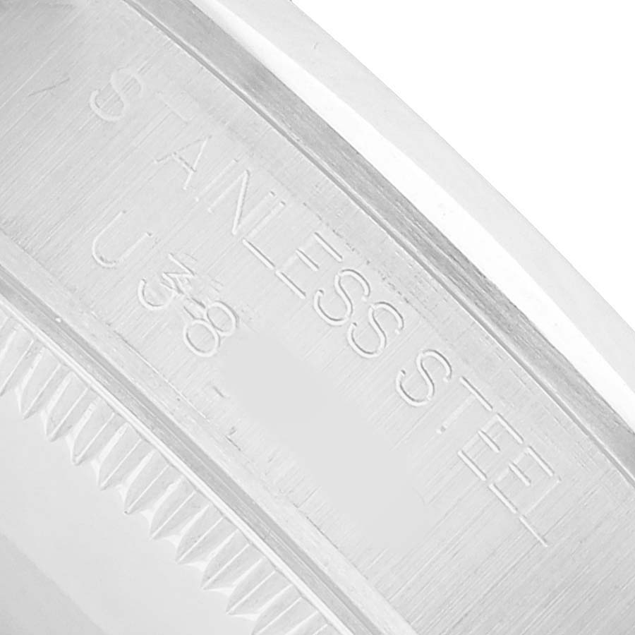 The image shows a close-up of the stainless steel case back engraving of a Mid-Size Rolex watch.