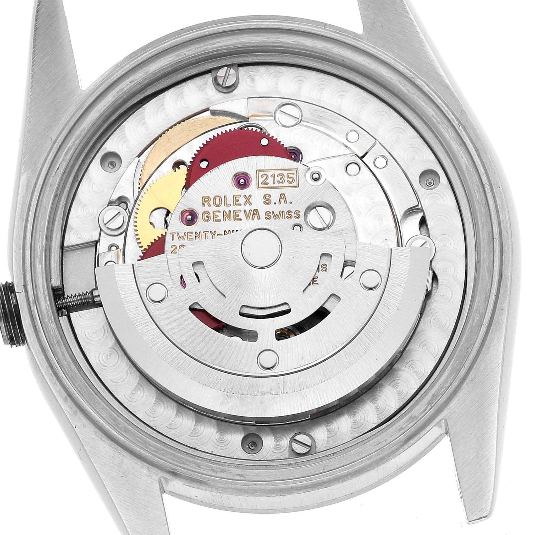 The image shows the back of a Rolex Mid-Size 68240 Women's Stainless Steel Pink Dial watch, revealing its movement parts.