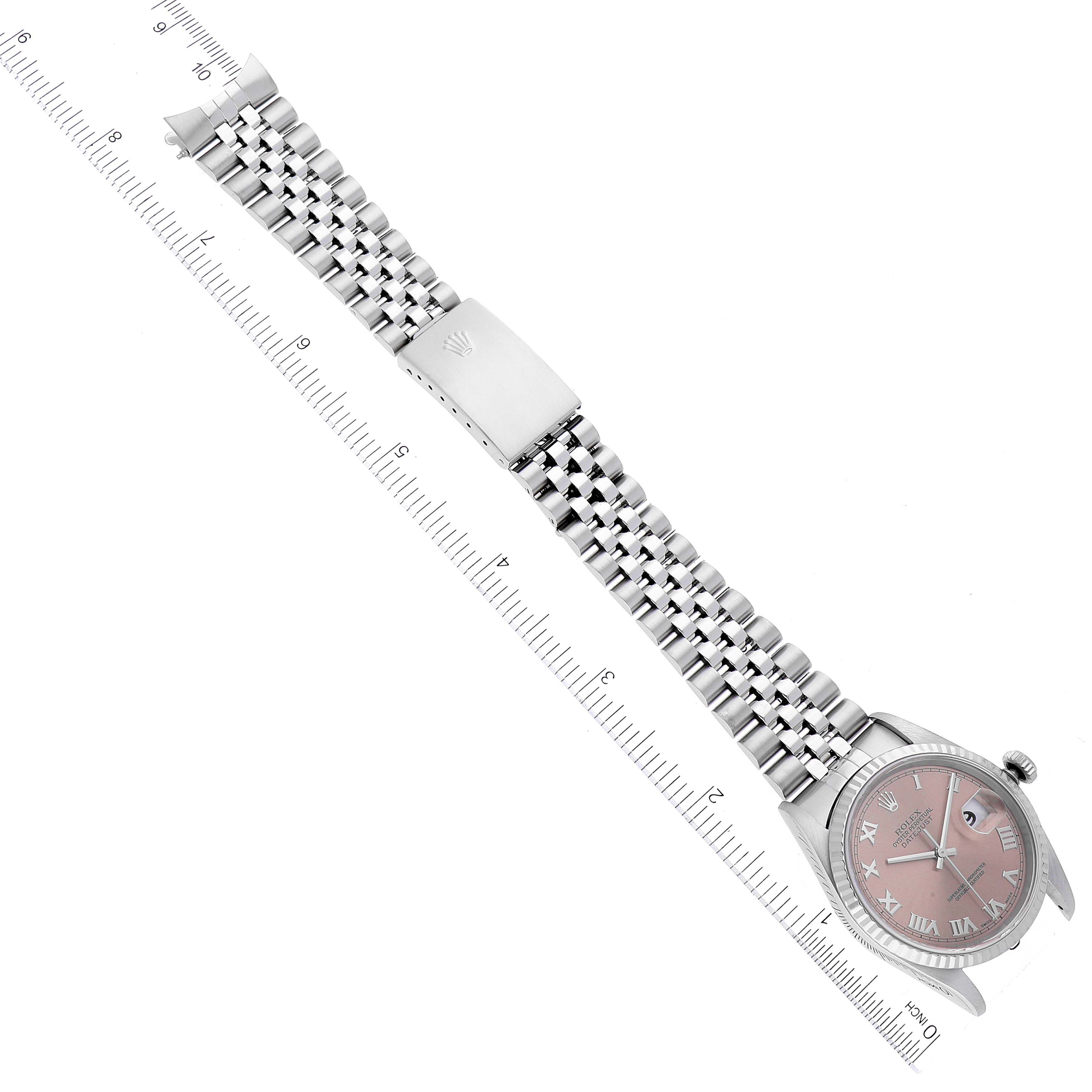 The image shows a Rolex Datejust 16234 Men's Stainless Steel Pink Dial 16234 Men's Stainless Steel Pink Dial watch at a top-down angle, displaying its face, bracelet, and clasp alongside a measurement ruler.