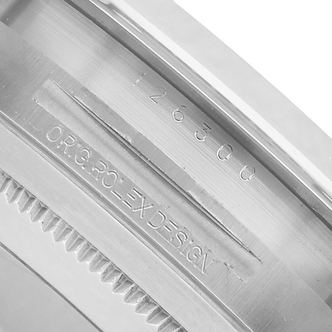 The image shows a close-up of the inner bezel and serial engraving of a Rolex Datejust 41 126300 Men's Stainless Steel Black Dial.