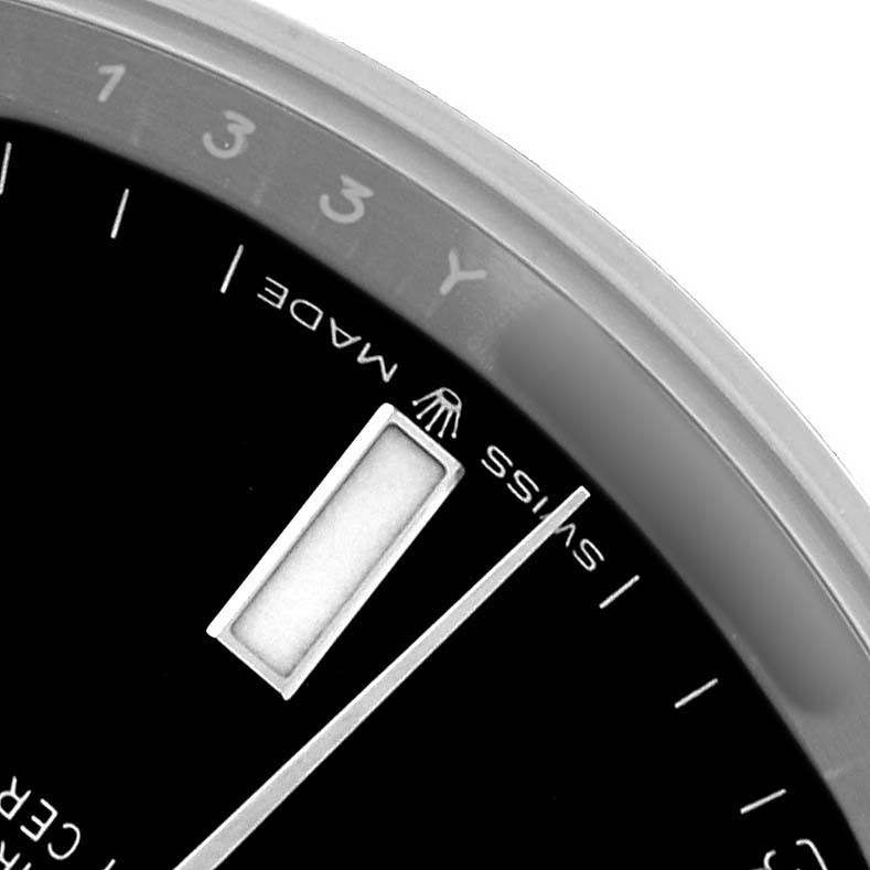 The image shows a close-up of the dial of a Rolex Datejust 41 126300 Men's Stainless Steel Black Dial, highlighting part of the bezel and hour markers.