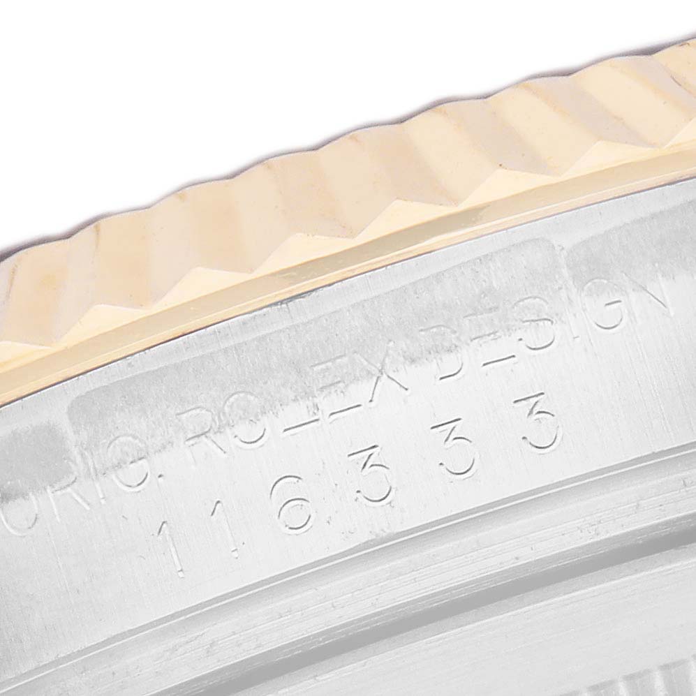 The image shows a close-up of the fluted bezel and engraved edge of a Rolex Datejust 41 116333 Men's Steel and Gold (two tone) Silver Dial watch.