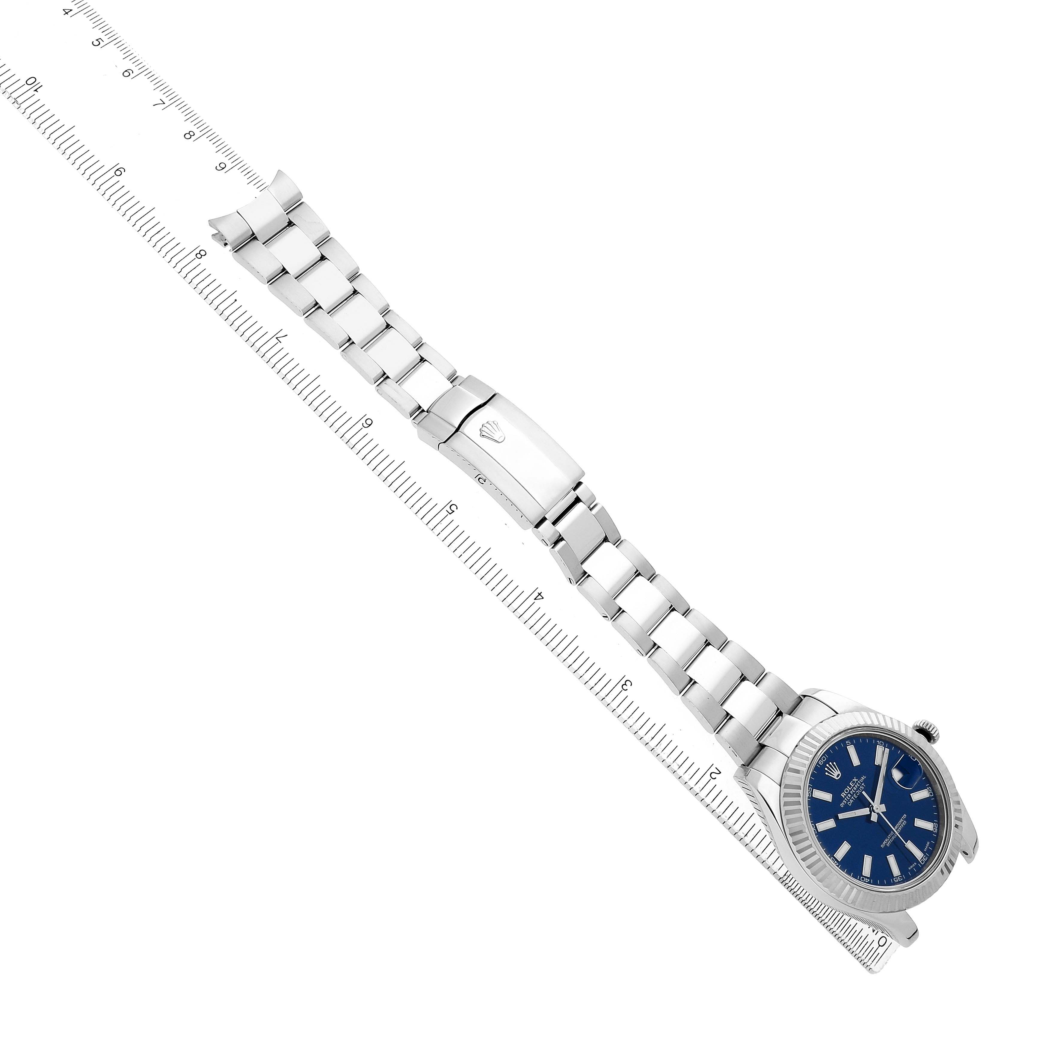 The image shows a Rolex Datejust 41 116334 Men's Stainless Steel Blue Dial watch from a top view, displaying the bracelet, clasp, and watch face aligned with a ruler.