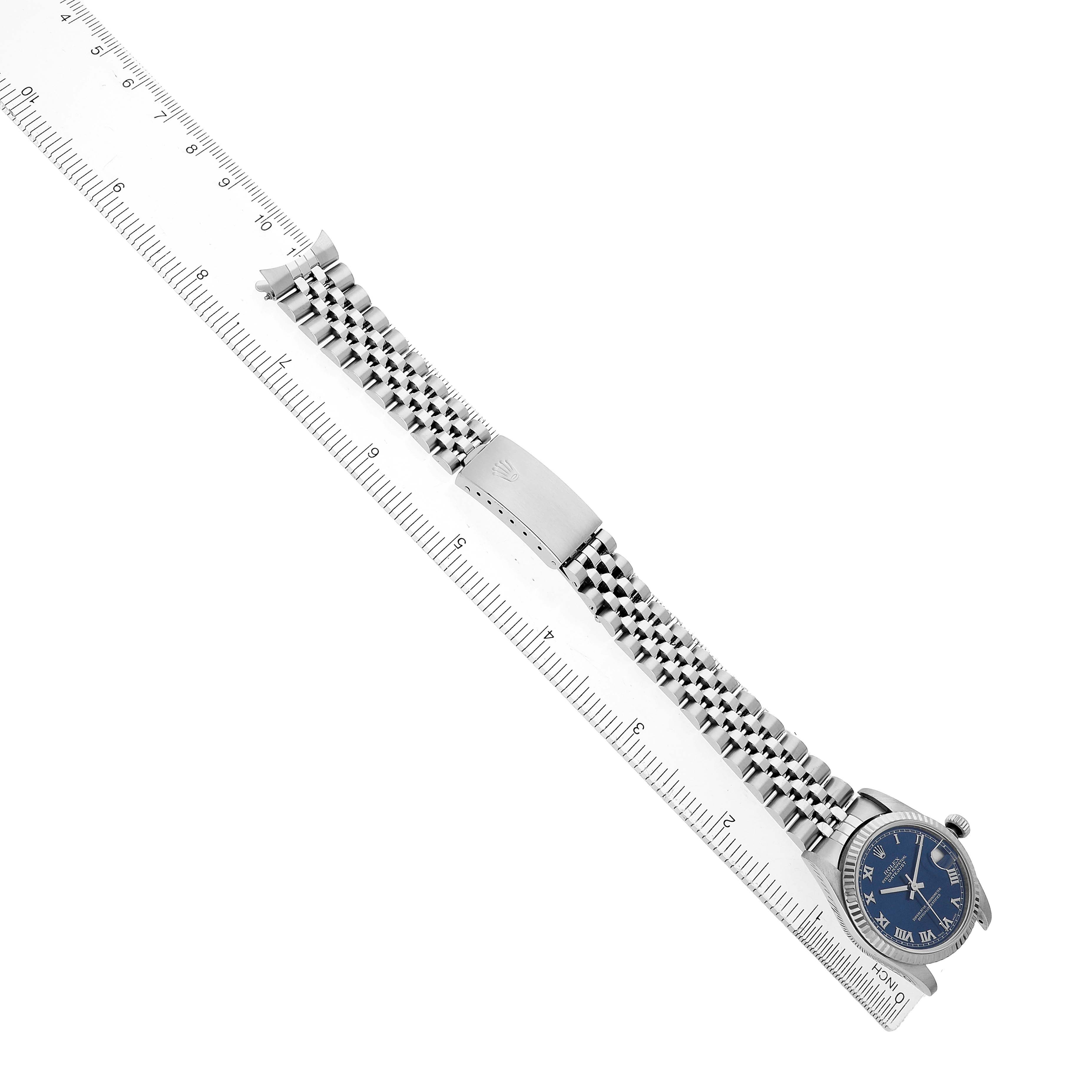 The image shows a Rolex Mid-Size 68274 Women's Stainless Steel Blue Dial watch at an angle with the face, bracelet, and clasp visible, beside a ruler for scale.