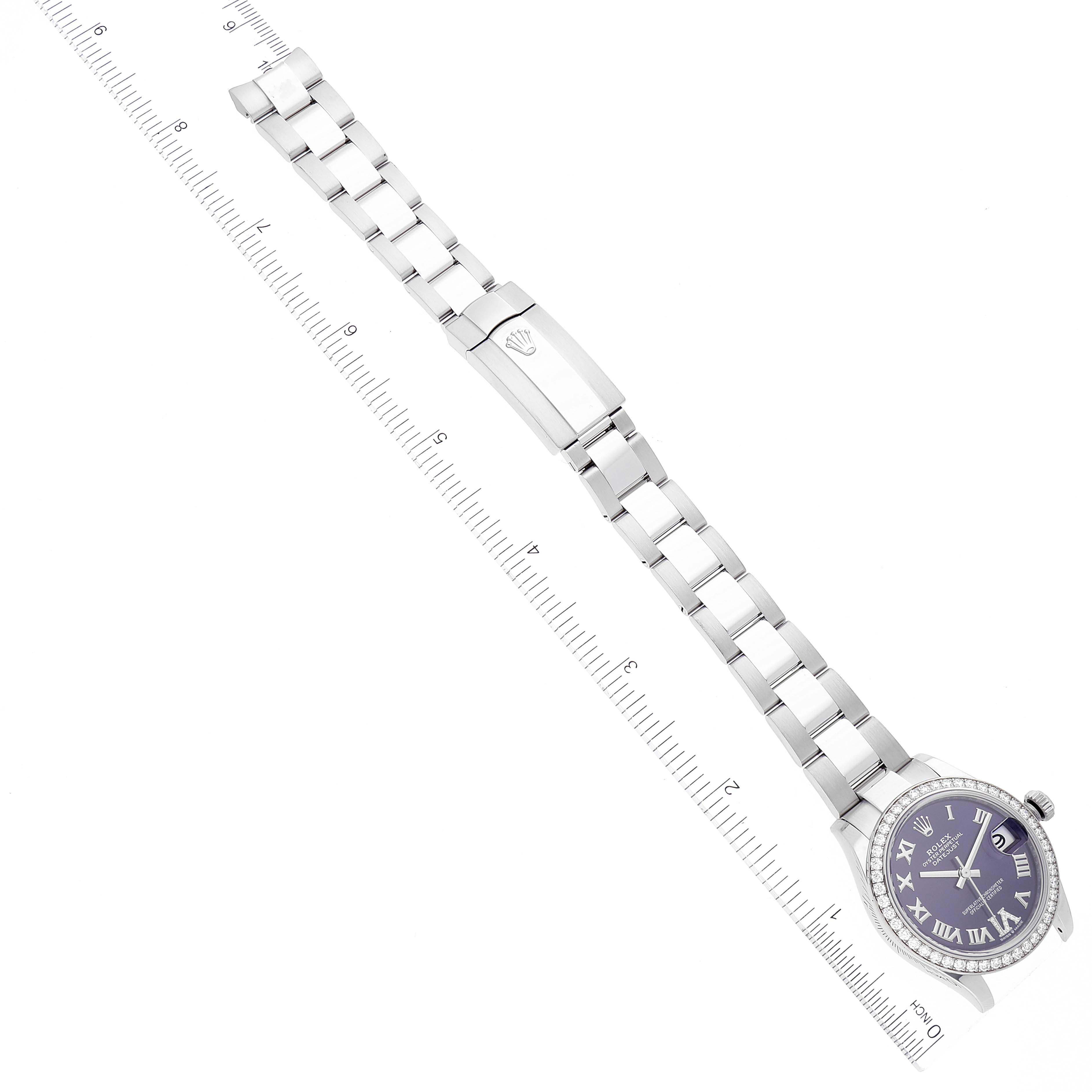 The image shows a top view of a Rolex Mid-Size 278384 Women's Stainless Steel Purple Dial 278384 Women's Stainless Steel Purple Dial model watch, displaying the face, bracelet, and clasp next to a measuring scale.