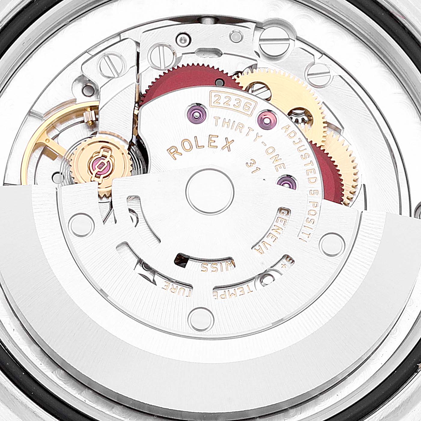 The image shows a close-up of the movement inside a Mid-Size Rolex watch, highlighting gears and internal mechanics.