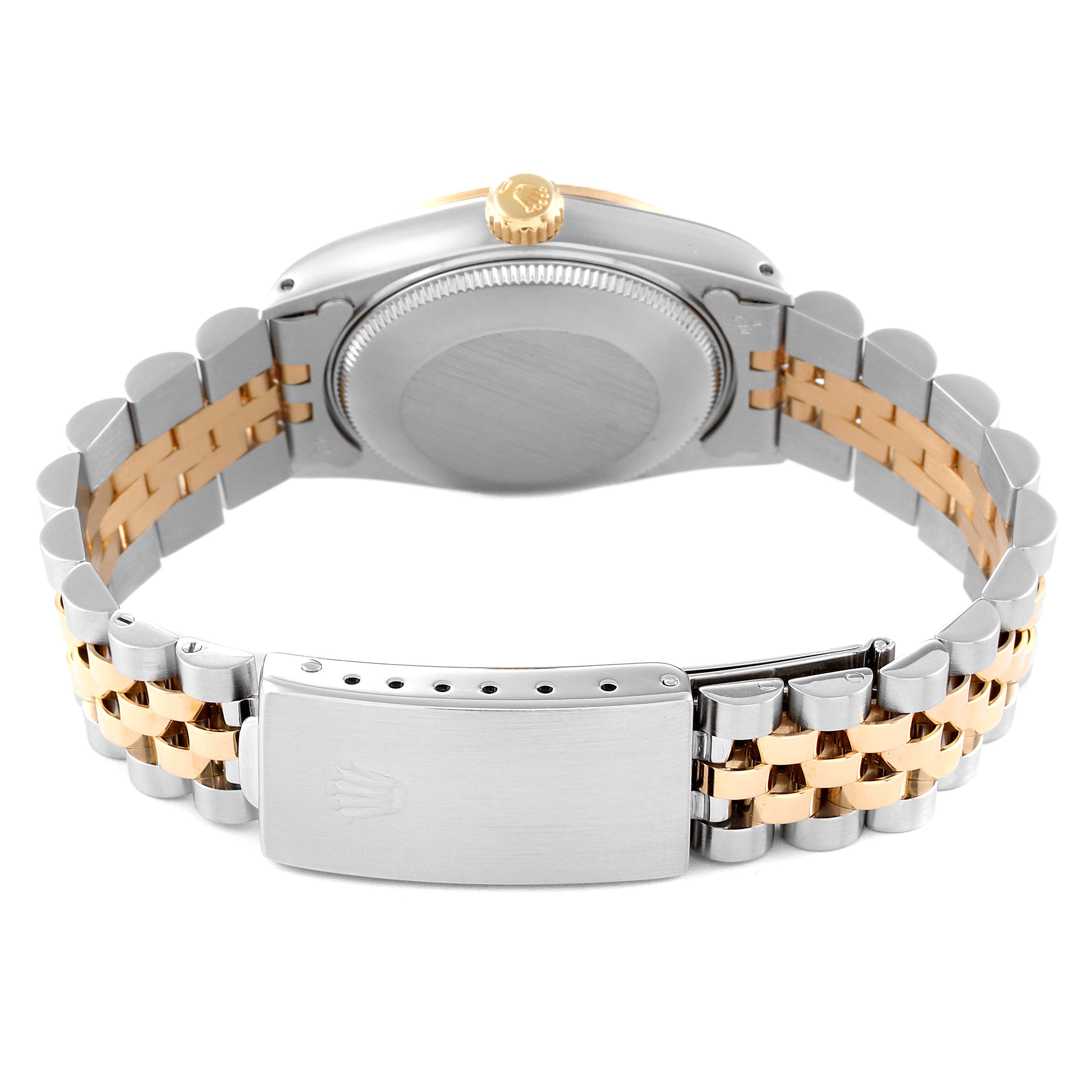 This image shows the back view of a Mid-Size Rolex watch, displaying the case back, crown, and bracelet with a clasp.