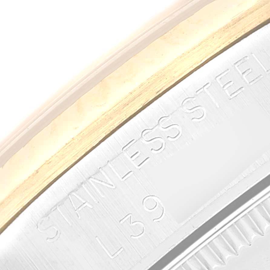 This image shows a close-up of the case edge and bezel of the Mid-Size Rolex watch, highlighting the "STAINLESS STEEL" engraving.