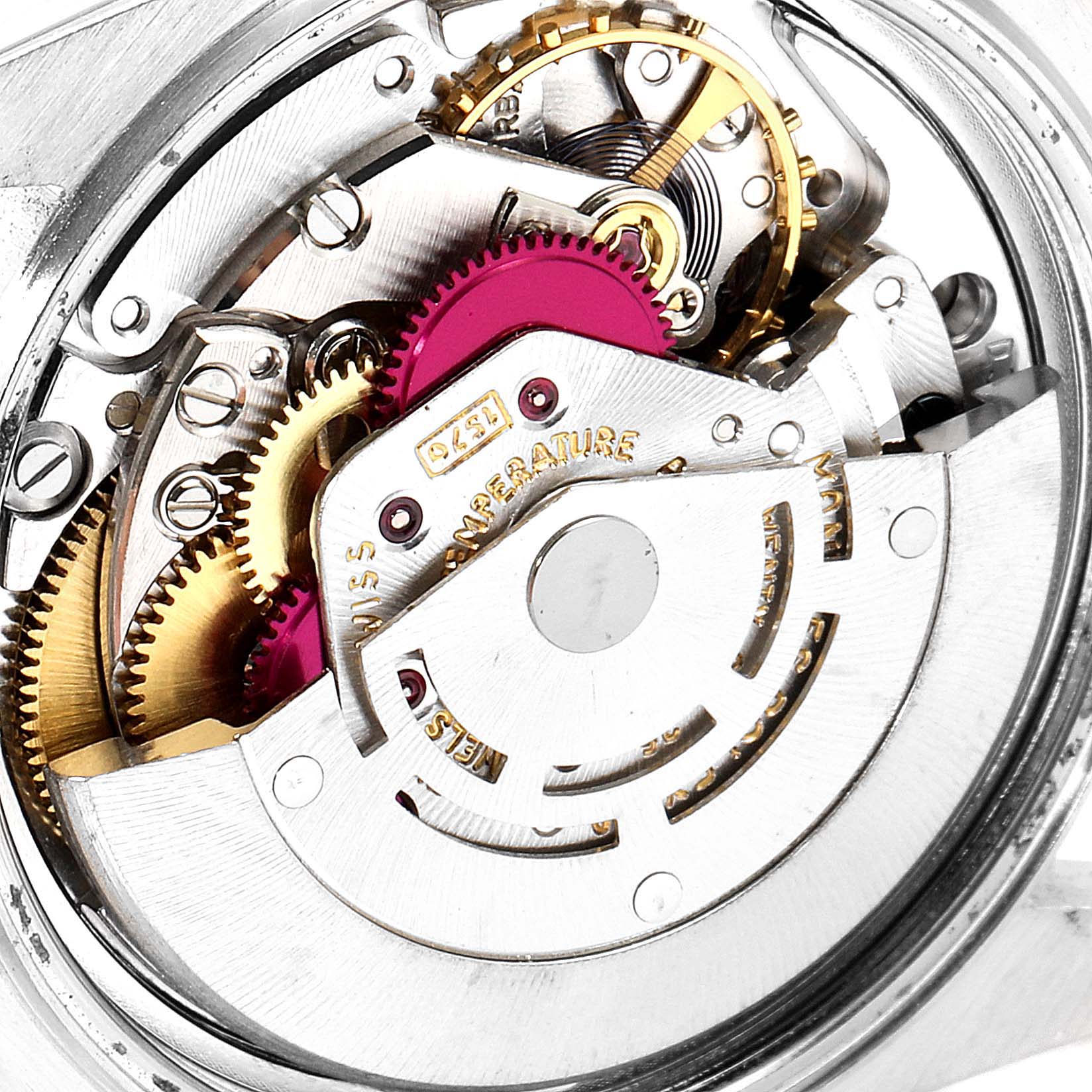 The image shows a close-up view of the mechanical movement inside a Vintage Collection watch by Rolex, highlighting gears and mechanisms.
