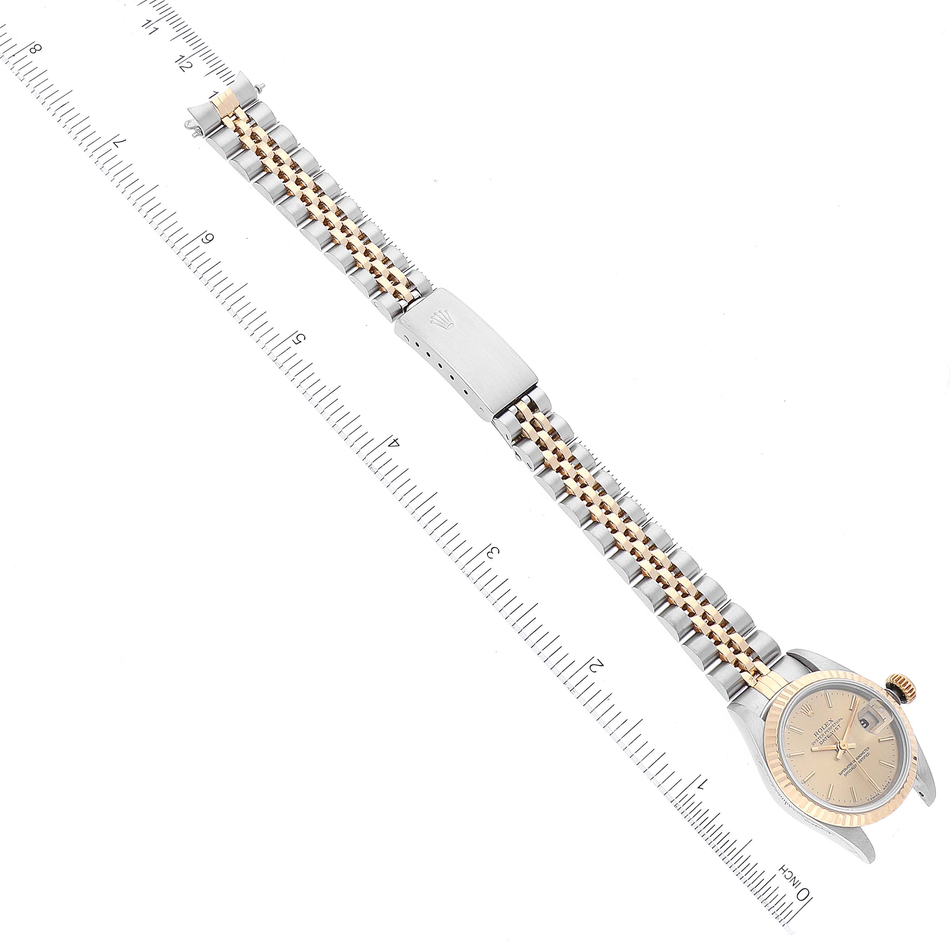 The image shows a Rolex Datejust 69173 Women's Steel and Gold (two tone) Champagne Dial 69173 Women's Steel and Gold (two tone) Champagne Dial watch laid flat with its band extended, positioned alongside a ruler for measuring.