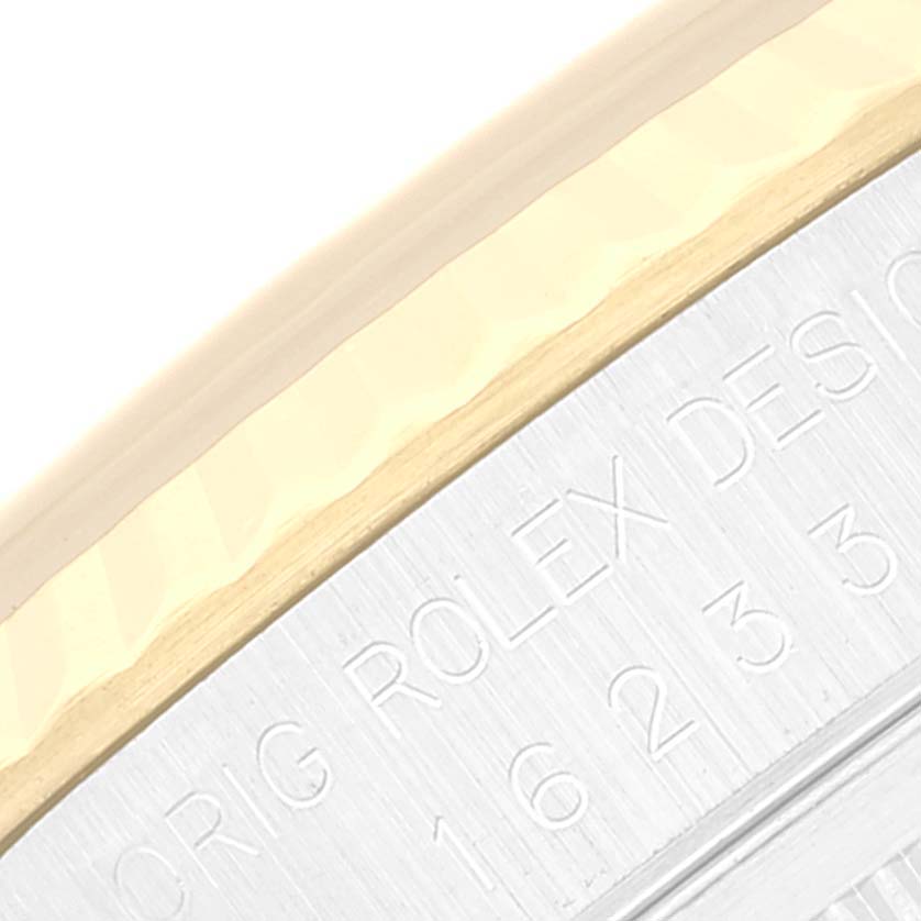 This image shows a close-up of the engraved rim on a Rolex Datejust 16233 Men's Steel and Gold (two tone) Champagne Dial 16233 Men's Steel and Gold (two tone) Champagne Dial model watch.