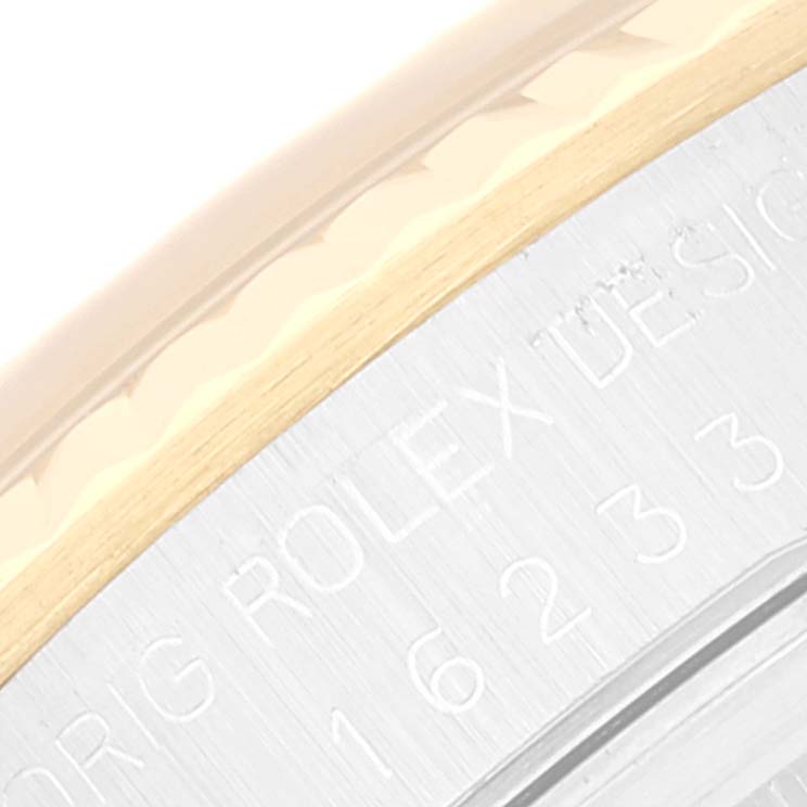 The image shows a close-up of the side of a Rolex Datejust 16233 Men's Steel and Gold (two tone) Champagne Dial 16233 Men's Steel and Gold (two tone) Champagne Dial watch case, highlighting its design engravings.
