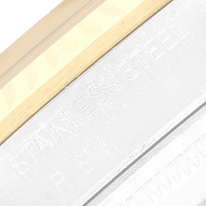 This close-up image shows part of the stainless steel casing of a Rolex Datejust 16233 Men's Steel and Gold (two tone) Champagne Dial 16233 Men's Steel and Gold (two tone) Champagne Dial watch.