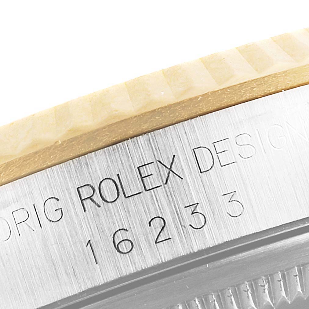 This image shows a close-up of the engraved model number and branding on the bezel and case of a Rolex Datejust 16233 Men's Steel and Gold (two tone) Champagne Dial 16233 Men's Steel and Gold (two tone) Champagne Dial watch.