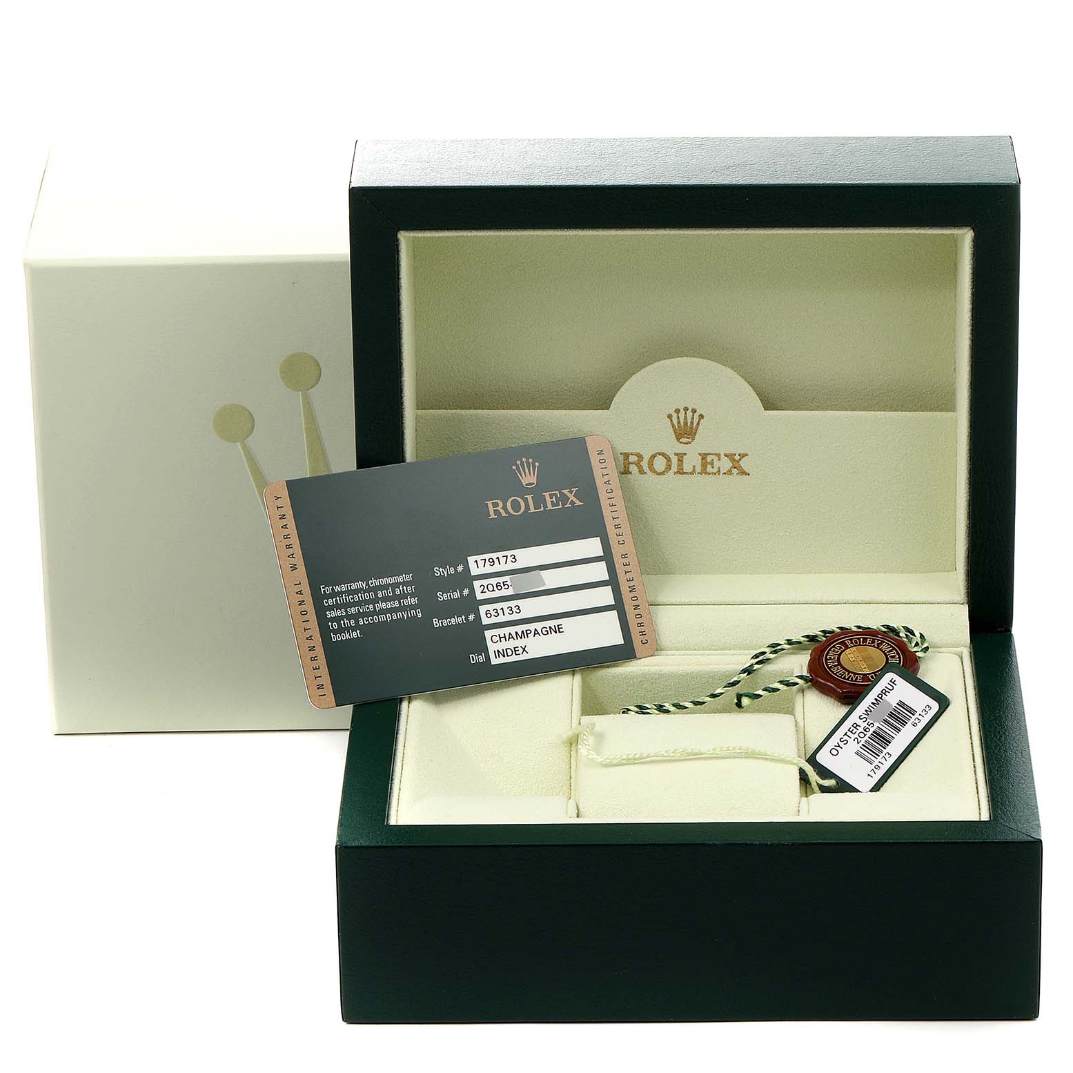 The image shows a Rolex Datejust 179173 Women
s Steel and Gold (two tone) Champagne Dial 179173 Women
s Steel and Gold (two tone) Champagne Dial watch box, warranty card, and a tag, viewed from the front.