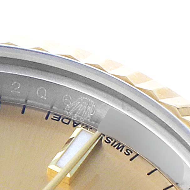 This is a close-up angle showing the dial and rehaut of the Rolex Datejust 179173 Women
s Steel and Gold (two tone) Champagne Dial 179173 Women
s Steel and Gold (two tone) Champagne Dial watch.