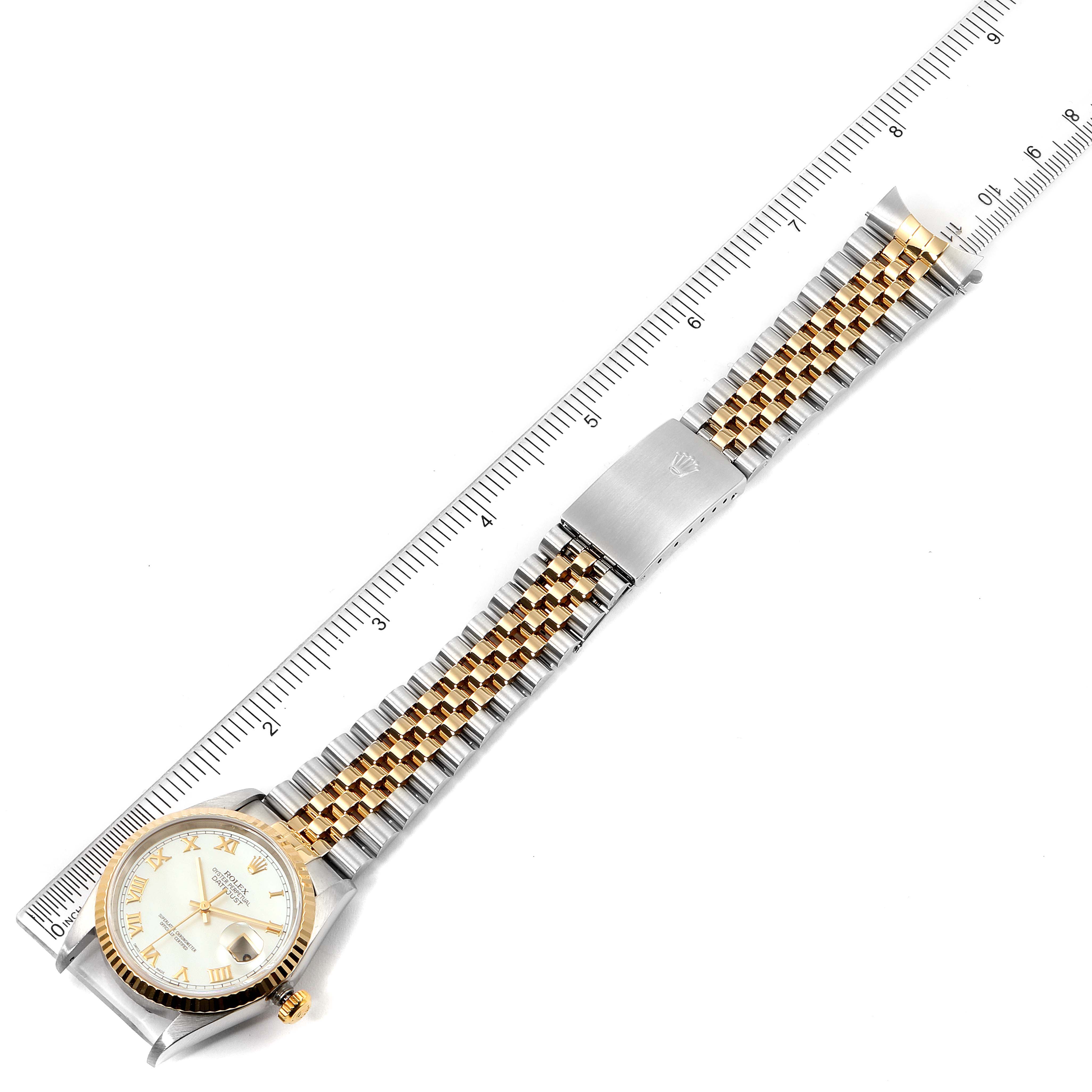 The image shows a Rolex Datejust 16233 Men
s Steel and Gold (two tone) Mother of Pearl Dial 16233 Men
s Steel and Gold (two tone) Mother of Pearl Dial watch laid flat with its face, bezel, and two-tone bracelet visible, alongside a ruler for scale.