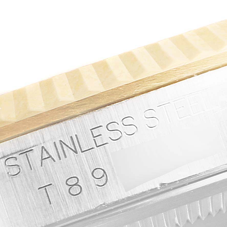 The image shows a close-up of the stainless steel and fluted bezel of a Rolex Datejust 16233 Men
s Steel and Gold (two tone) Mother of Pearl Dial 16233 Men
s Steel and Gold (two tone) Mother of Pearl Dial watch.