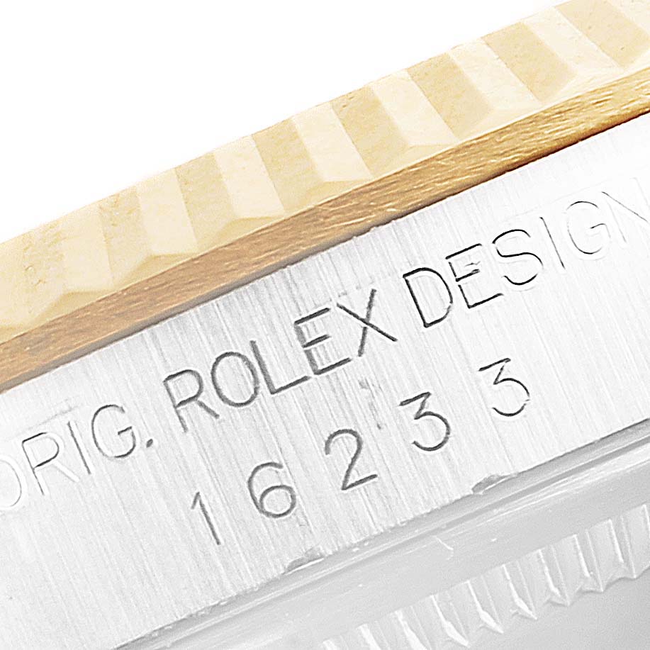 The image shows a close-up of the bezel and part of the caseback with engravings on a Rolex Datejust 16233 Men
s Steel and Gold (two tone) Mother of Pearl Dial 16233 Men
s Steel and Gold (two tone) Mother of Pearl Dial watch.
