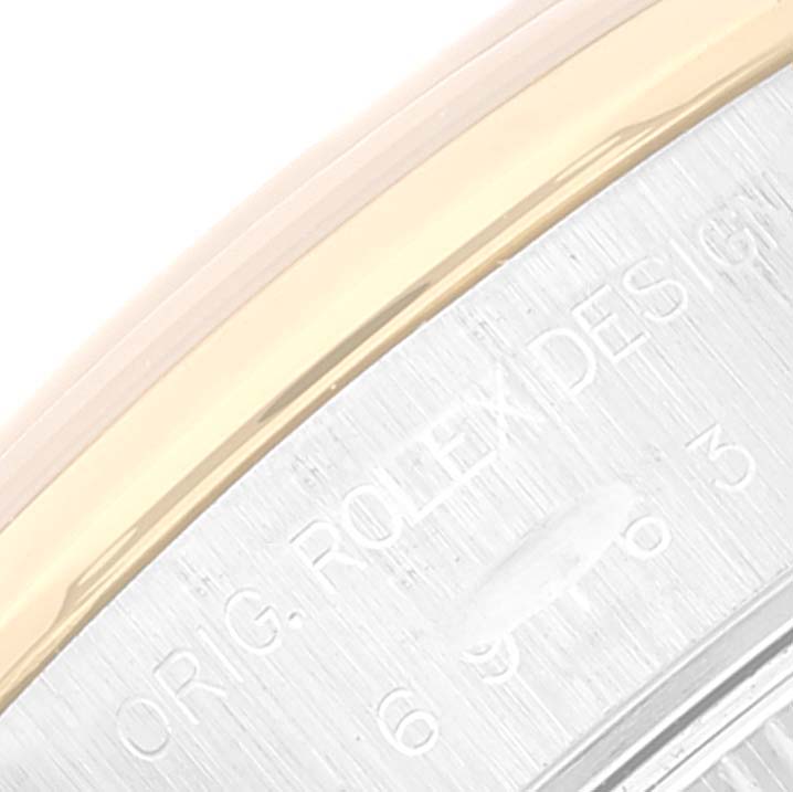 This image shows a close-up of the case and edge of the bezel of a Rolex Datejust 69163 Women's Steel and Gold (two tone) Grey Dial 69163 Women's Steel and Gold (two tone) Grey Dial watch.