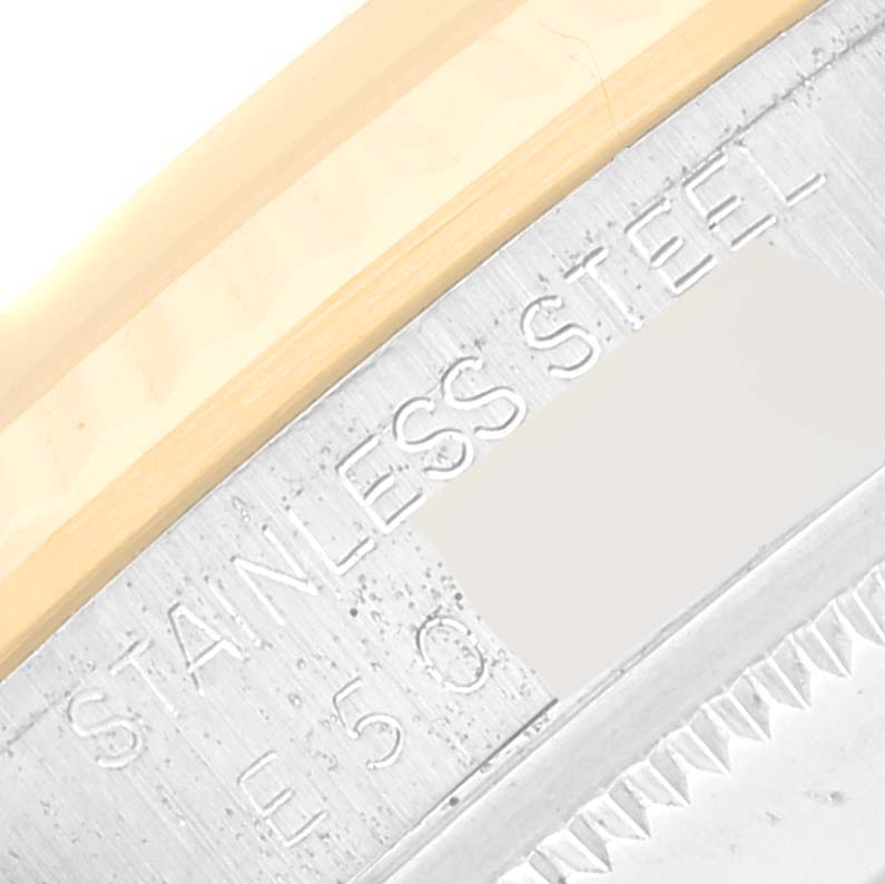 This close-up image shows the outer edge and part of the bezel of a Rolex Datejust 16233 Men's Steel and Gold (two tone) White Dial 16233 Men's Steel and Gold (two tone) White Dial watch, highlighting the "STAINLESS STEEL" engraving.