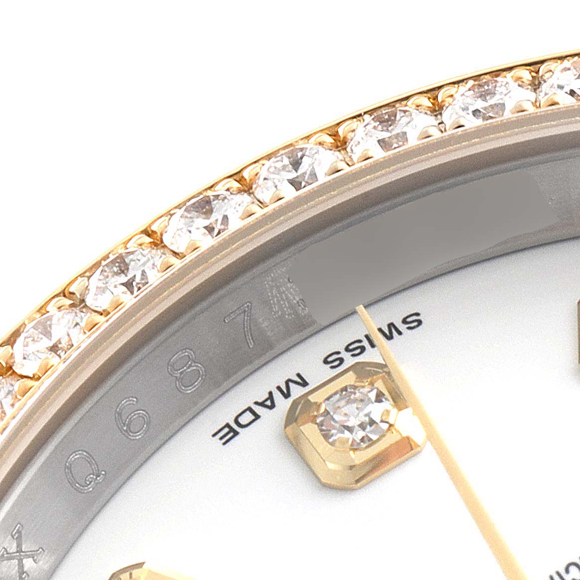 This close-up angle shows the diamond-studded bezel, dial markings, and a portion of the dial of the Rolex Datejust 116243 Men's Steel and Gold (two tone) White Dial 116243 Men's Steel and Gold (two tone) White Dial watch.