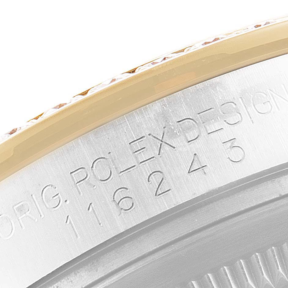 Close-up of the Rolex Datejust 116243 Men's Steel and Gold (two tone) White Dial 116243 Men's Steel and Gold (two tone) White Dial watch side, showing the serial number and "Rolex Design" engraving.
